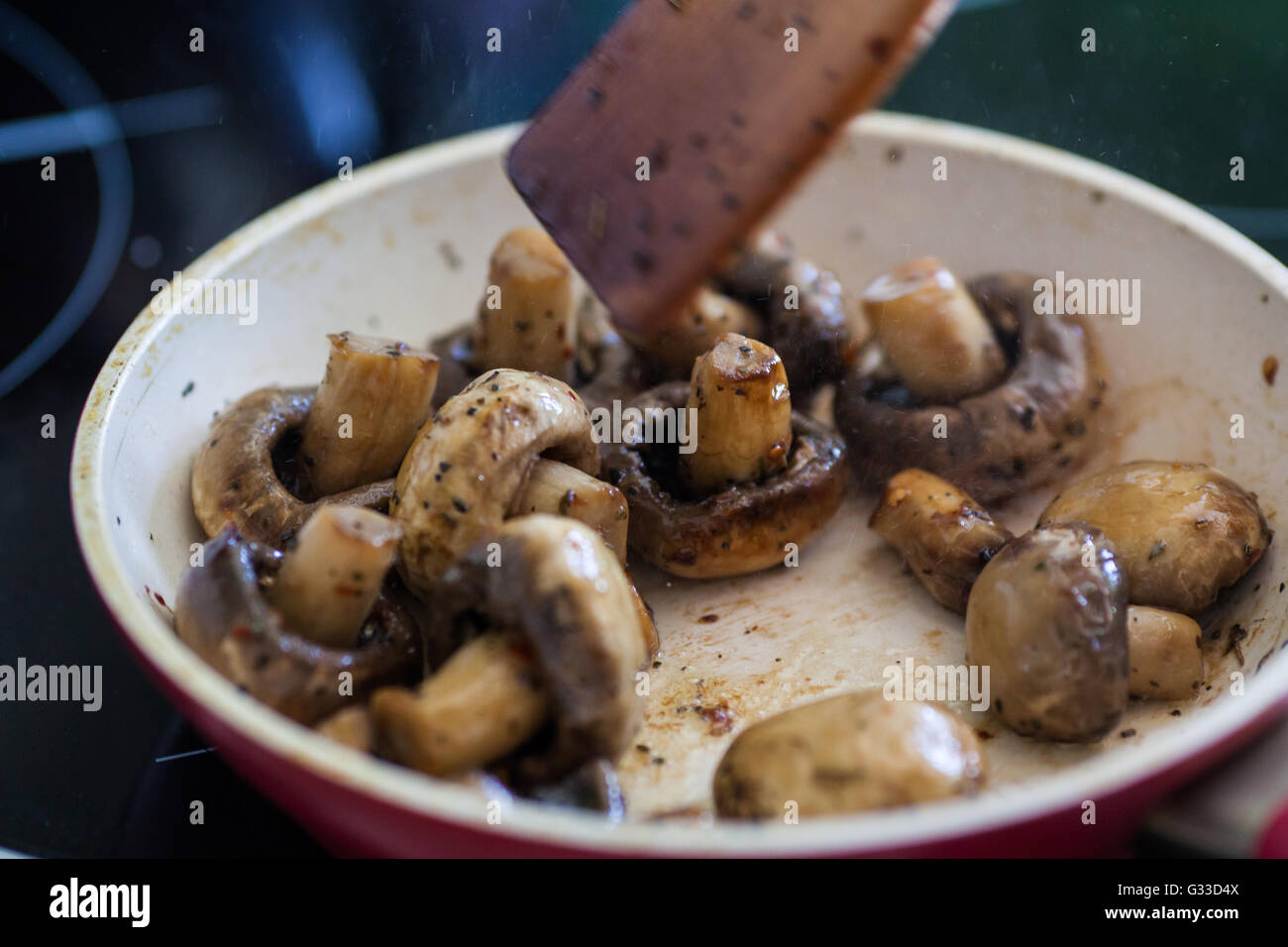 Roasted field mushrooms, champignons being cooked in frying pan, close