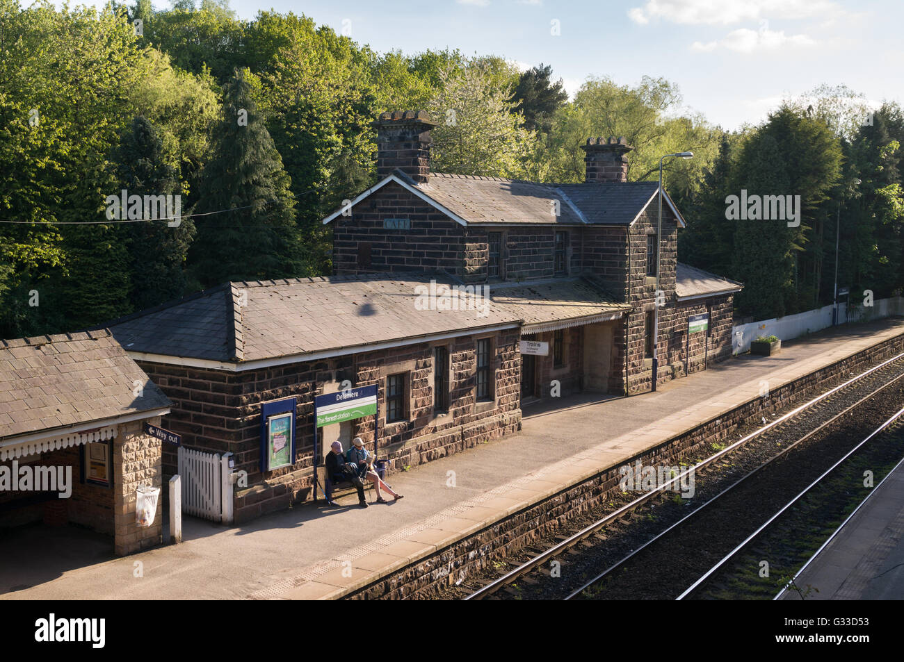 A couple waiting for a train on Delamere Railway Station , Cheshire, England, UK Stock Photo