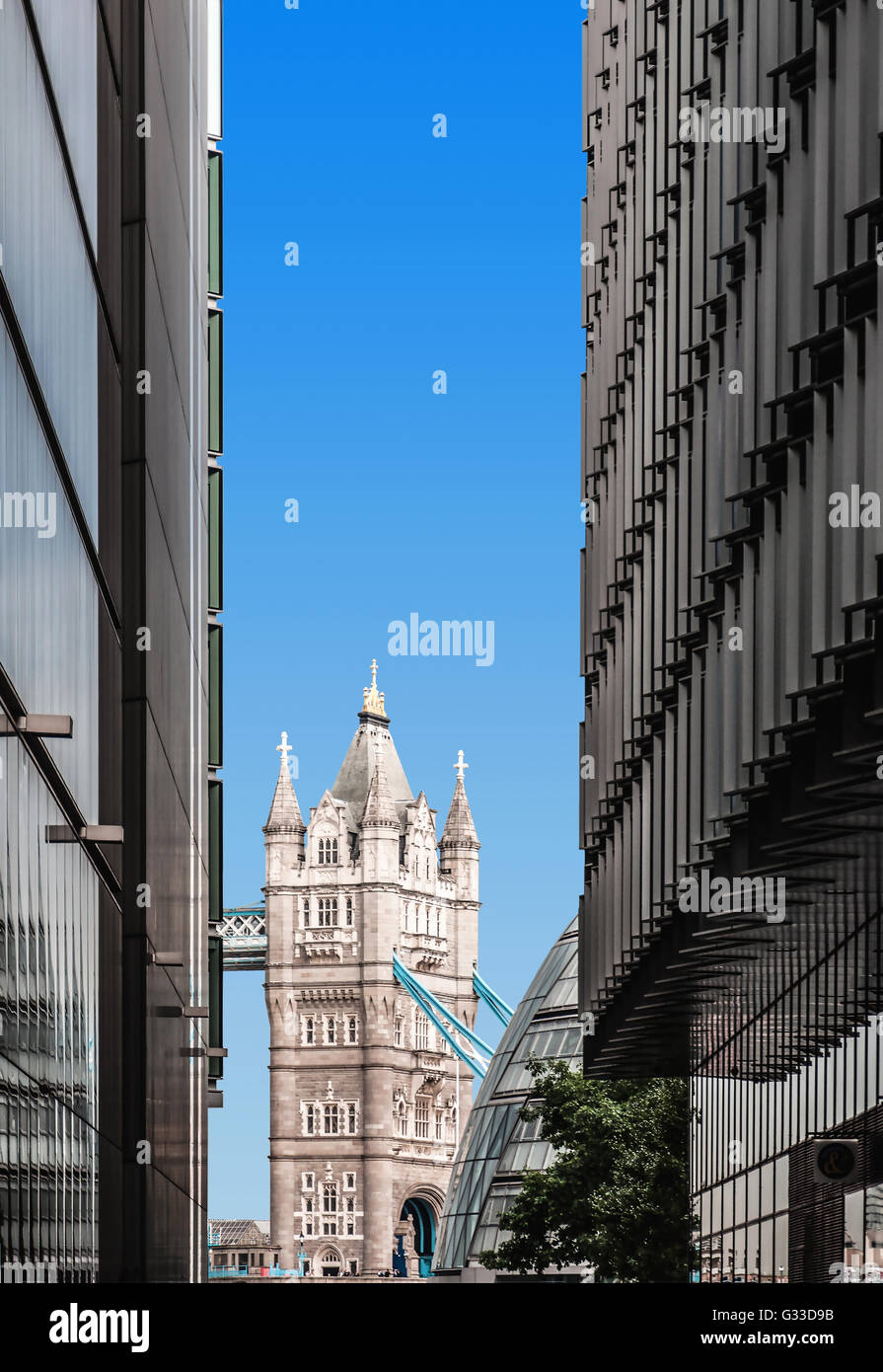 Tower Bridge viewed between modern buildings. Contrast of old and new London. Stock Photo