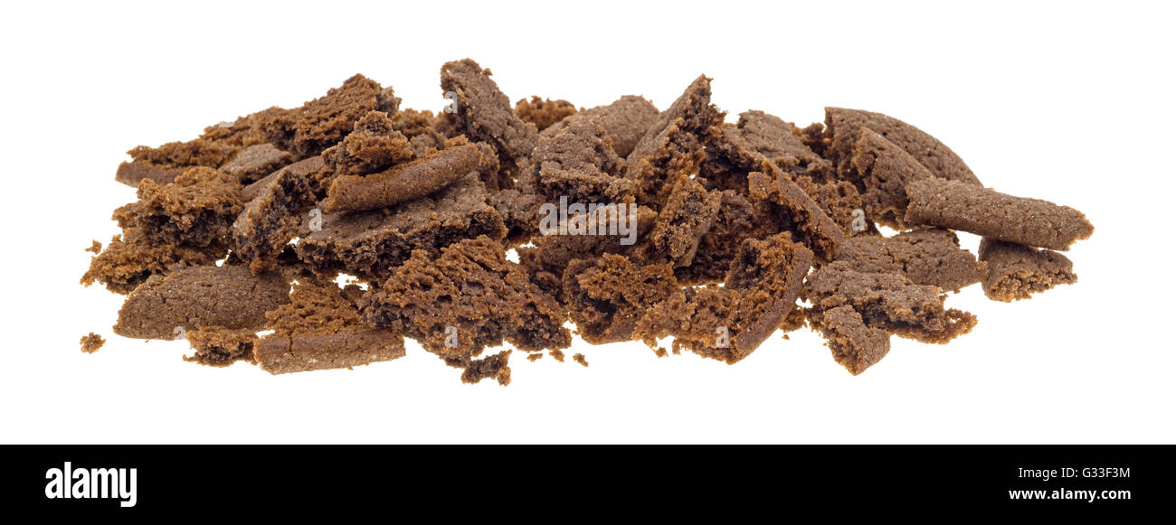Several Dutch cocoa cookies crumbled into pieces isolated on a white background. Stock Photo