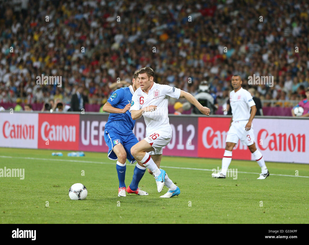 KYIV, UKRAINE - JUNE 24, 2012: James Milner of England (R) fights for a ball with Federico Balzaretti of Italy during their UEFA EURO 2012 Quarter-final game at Olympic stadium in Kyiv, Ukraine Stock Photo