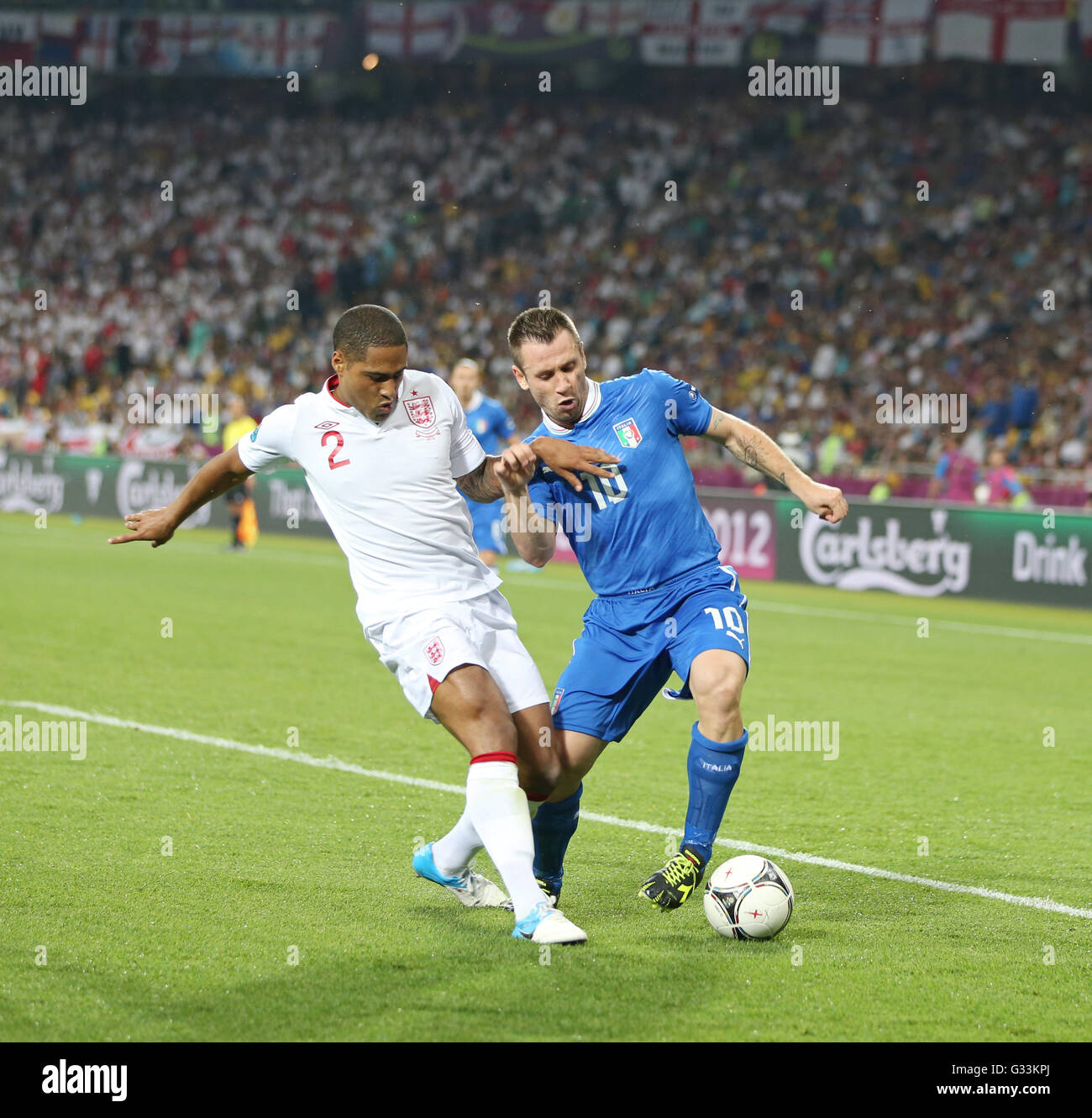 KYIV, UKRAINE - JUNE 24, 2012: Glen Johnson of England (L) fights for a ball with Antonio Cassano of Italy during their UEFA EURO 2012 Quarter-final game at Olympic stadium in Kyiv, Ukraine Stock Photo