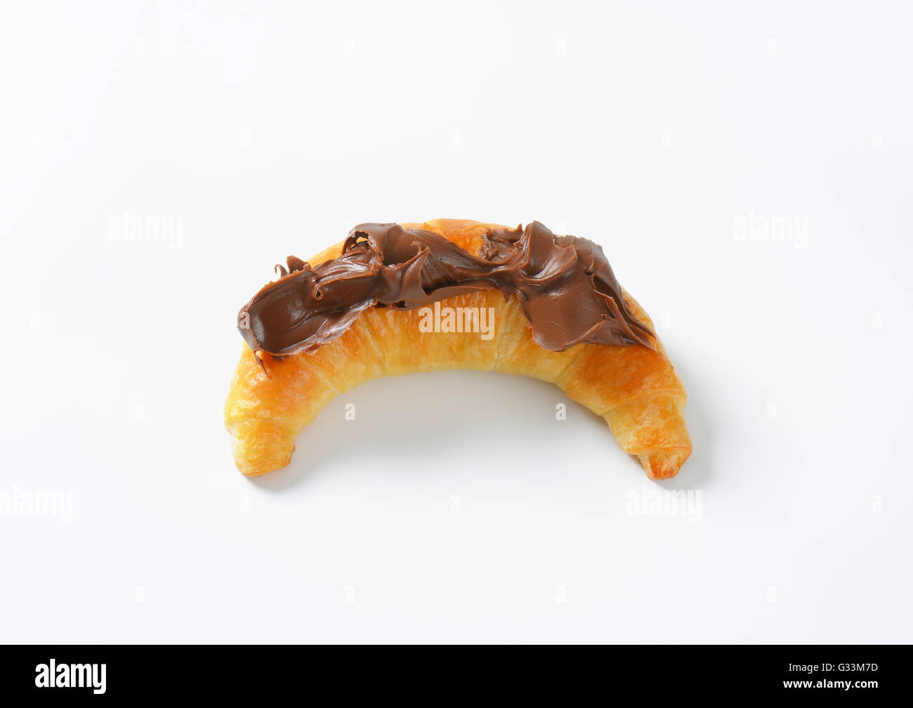 croissant topped with chocolate cream on white background Stock Photo