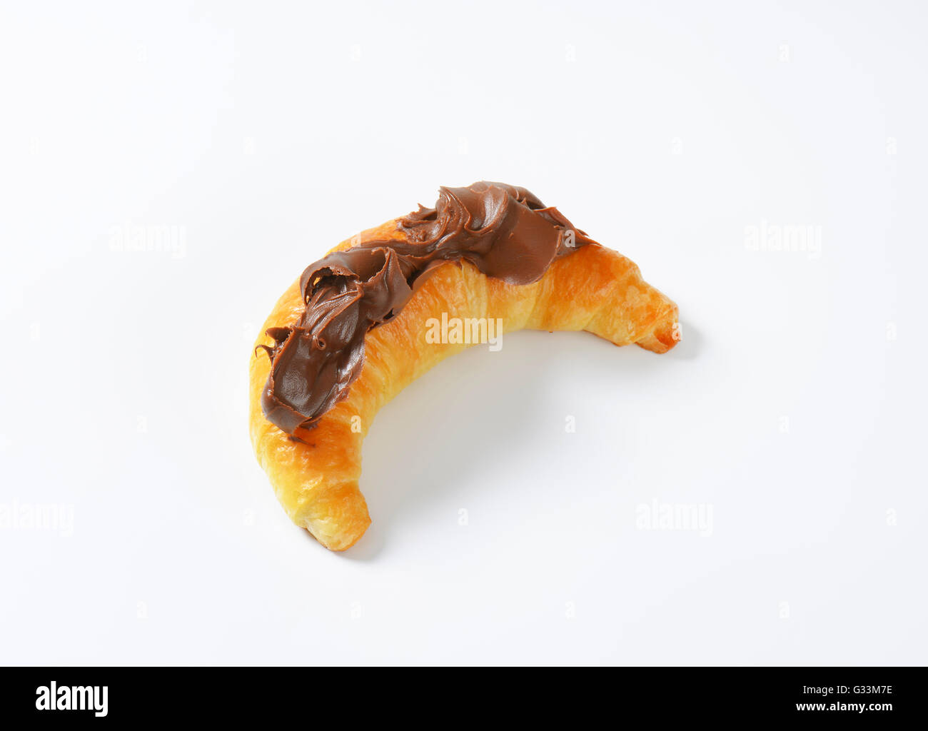 croissant topped with chocolate cream on white background Stock Photo