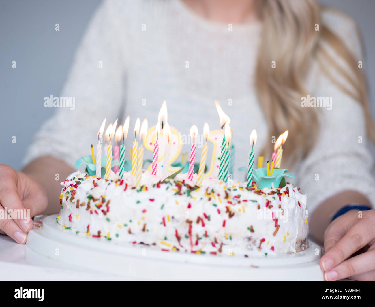 Portrait of a young beautiful blond girl holding plate with birthday ...
