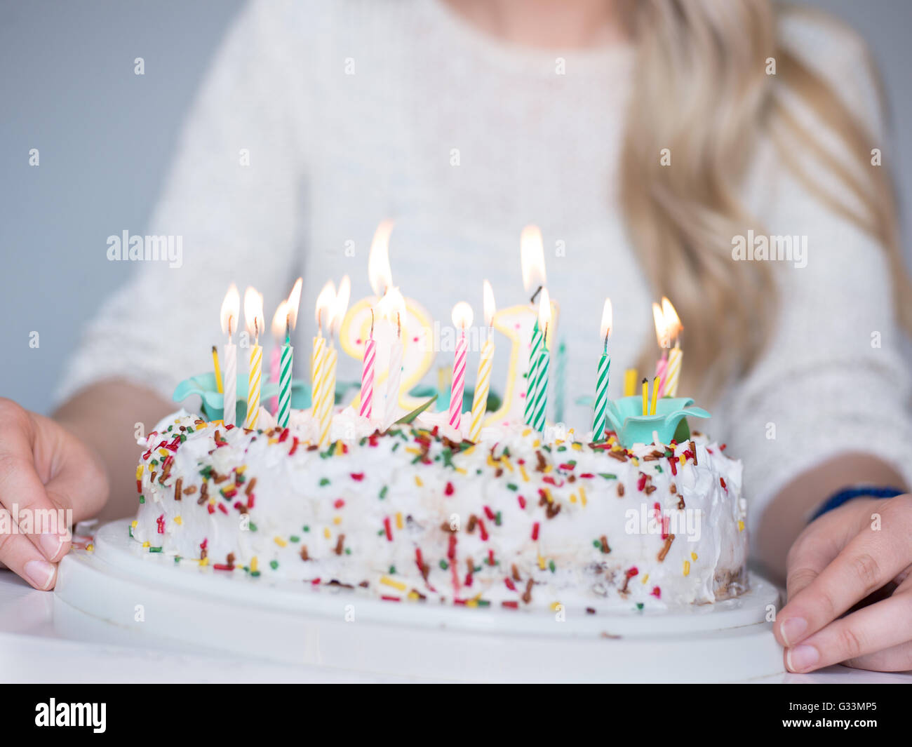 Portrait of a young beautiful blond girl holding plate with birthday ...