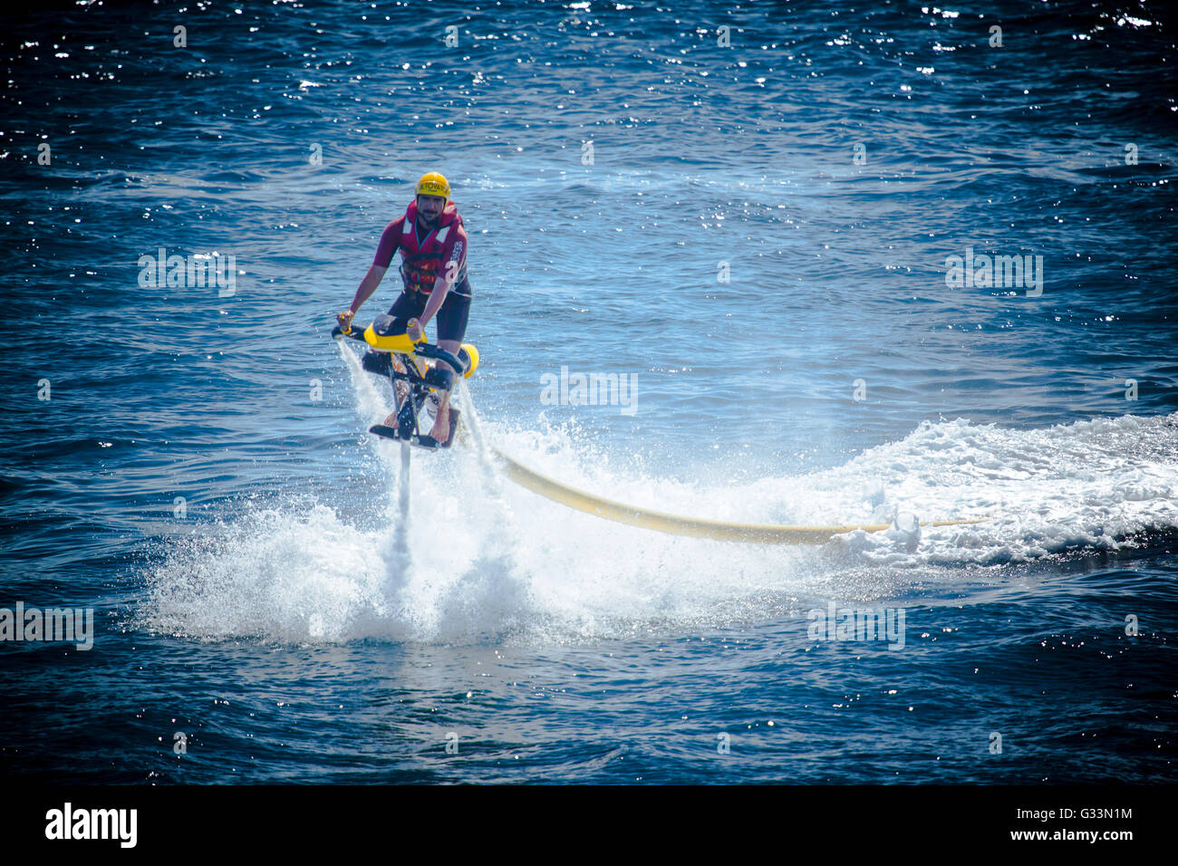 Young man doing watersports on a Jetovator aquatic vehicle Stock Photo