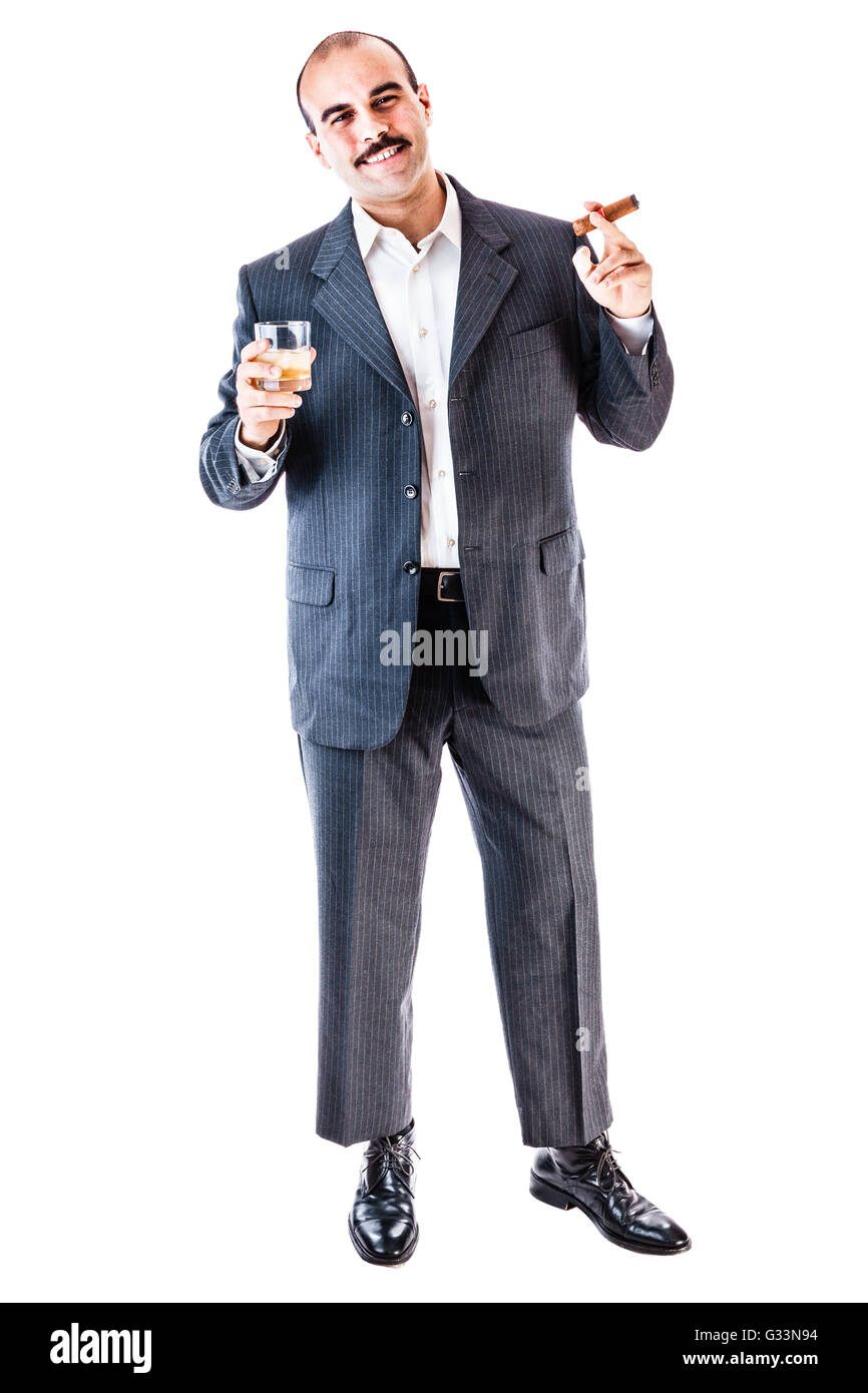 portrait of a classy businessman toasting with a glass of whiskey and smoking a cigar isolated over a white background Stock Photo