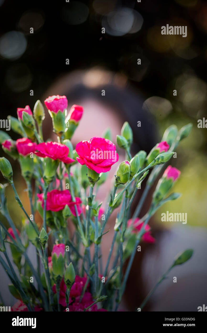a photo of a young woman with a bouquet of flowers Stock Photo - Alamy
