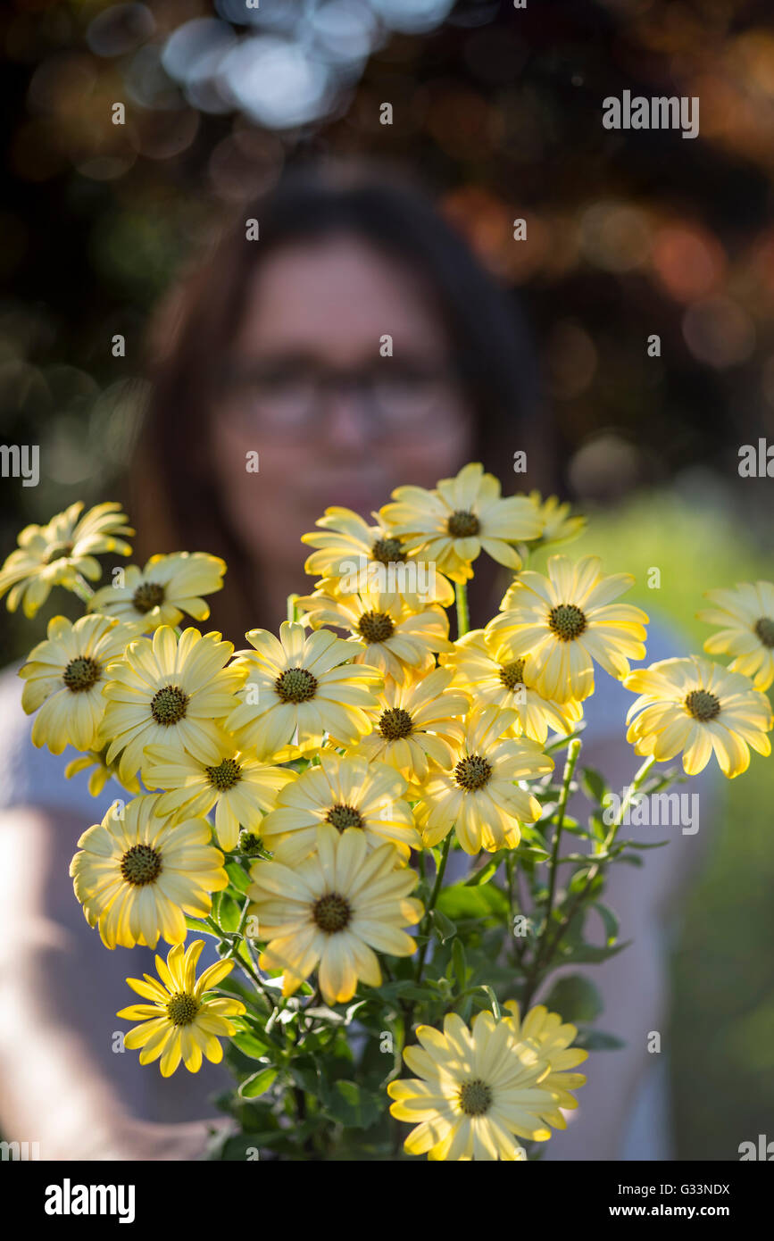 a photo of a young woman with a bouquet of flowers Stock Photo