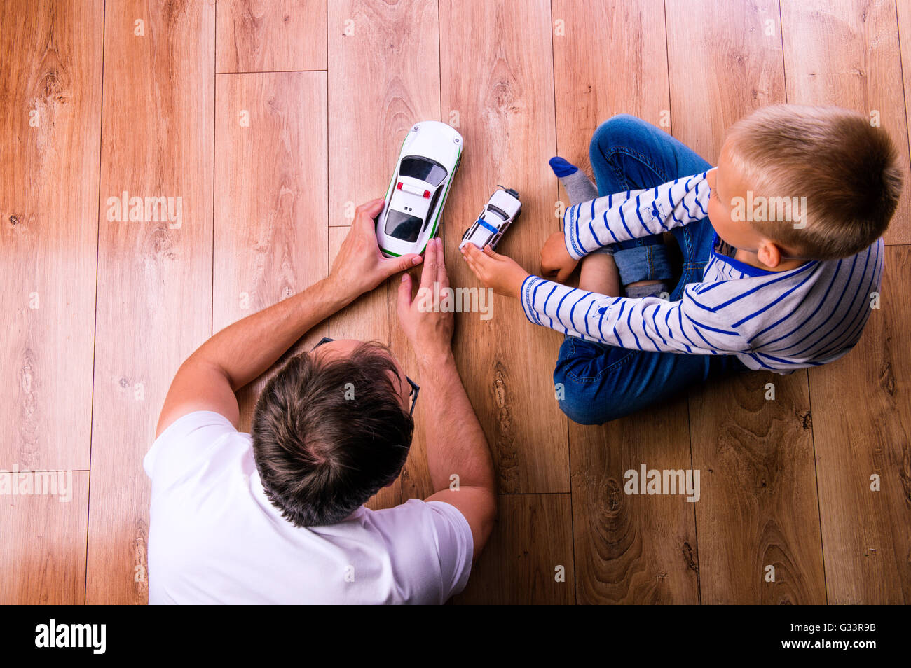 Unrecognizable father with his son playing with cars Stock Photo