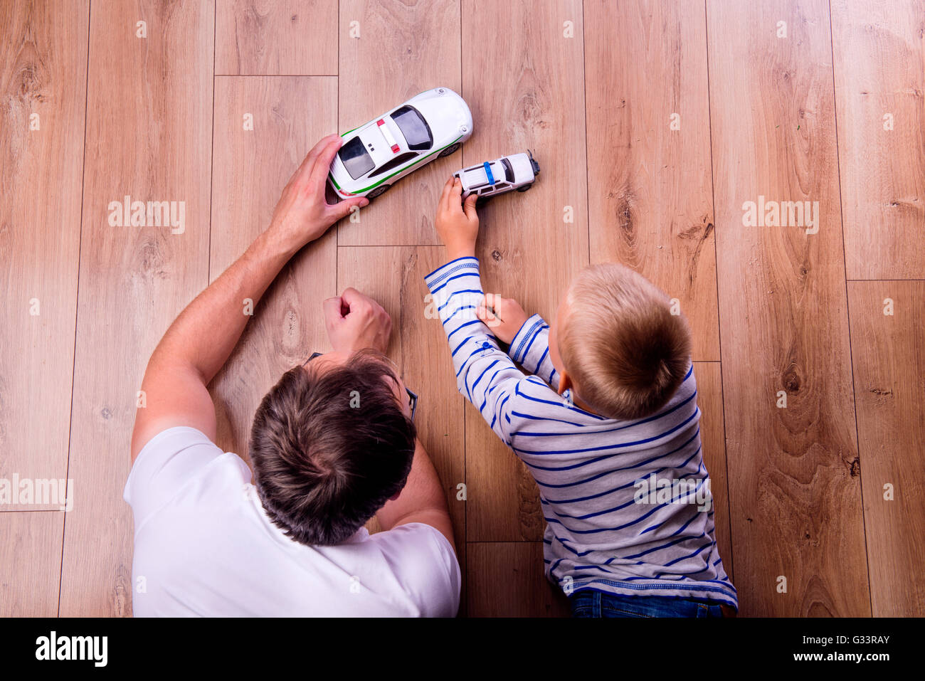 Unrecognizable father with his son playing with cars Stock Photo