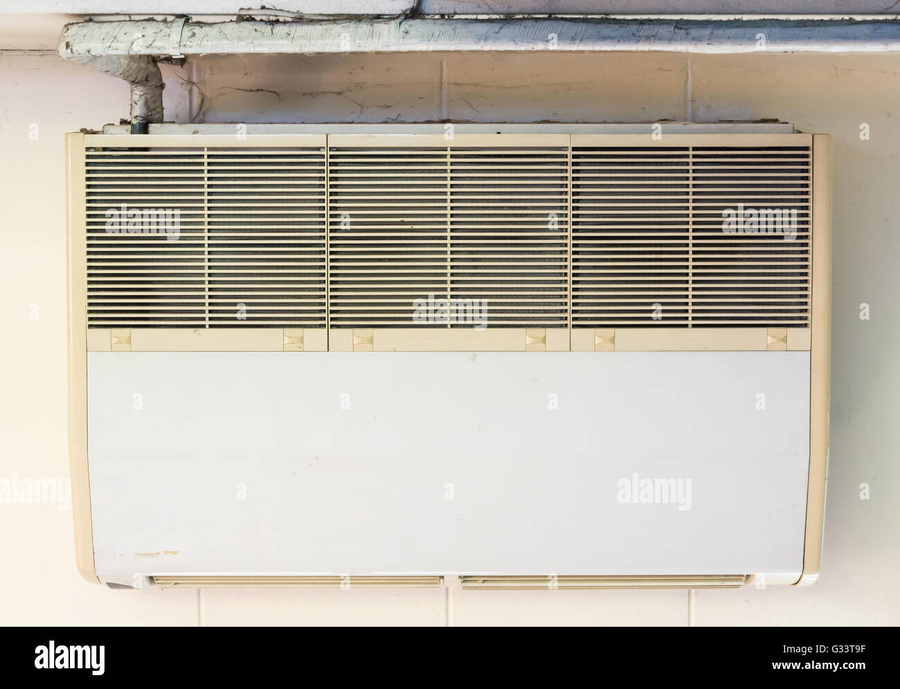Old air conditioner unit is hanging on the office ceiling Stock Photo -  Alamy