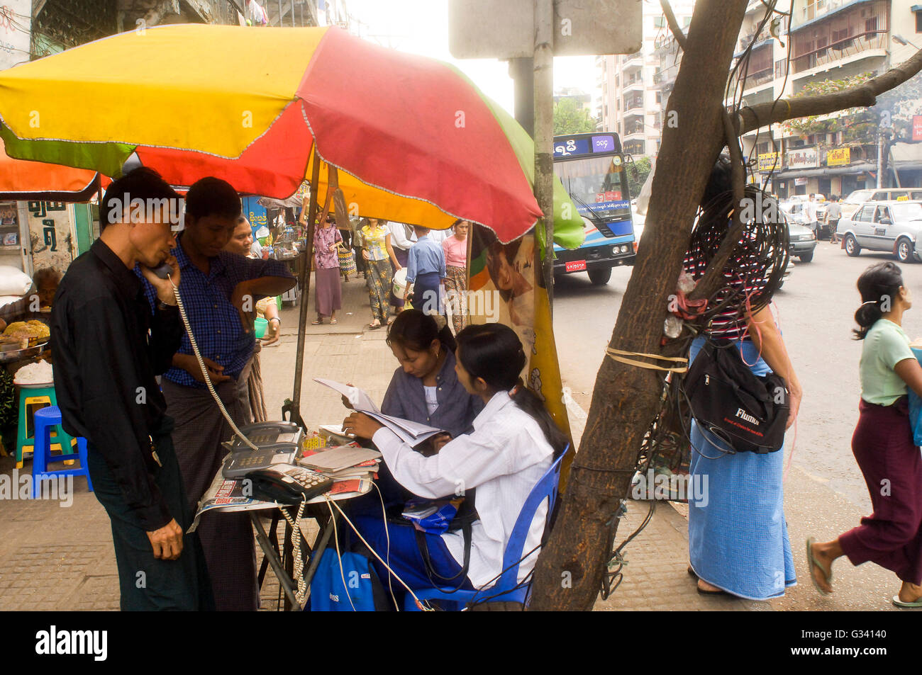 Myanmar, Yangon, People Public Phone Booth in the Street Stock Photo