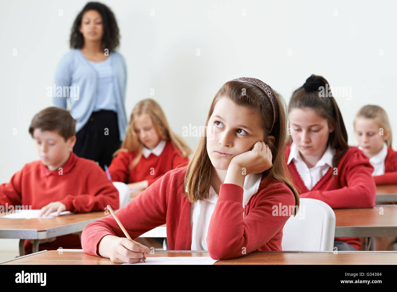 Female Pupil Finding School Exam Difficult Stock Photo