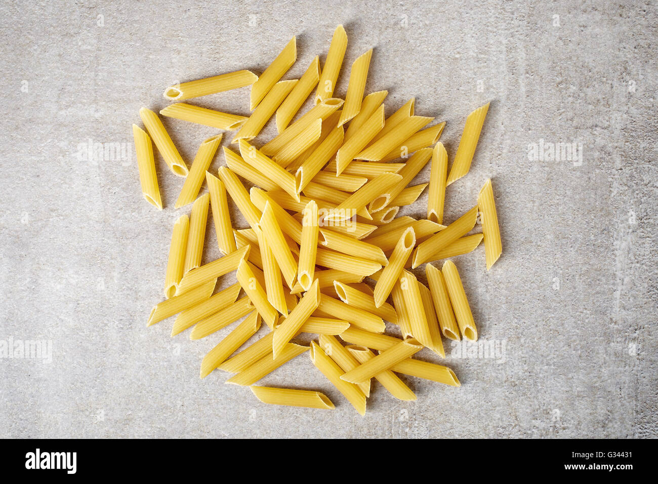 Penne pasta on stone table, top view Stock Photo