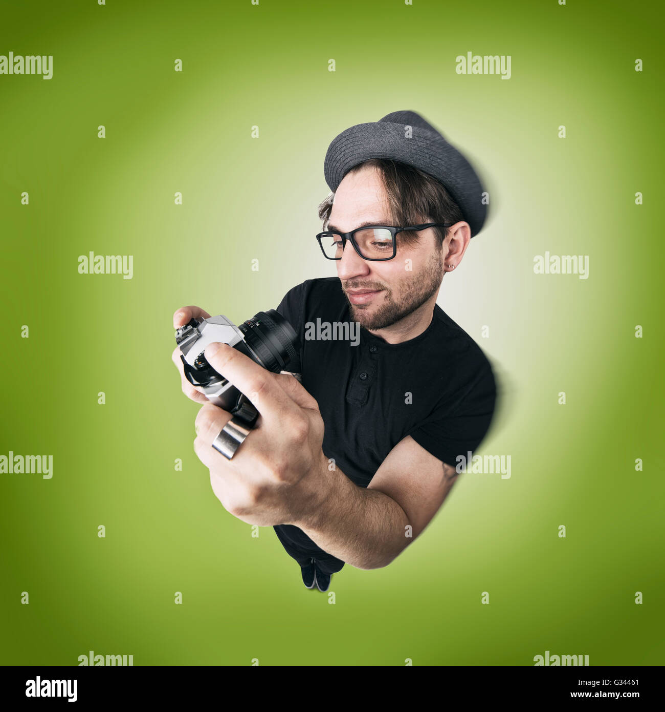 Funny Man with hat and photocamera selfie laugh looks like caricature of himself Stock Photo