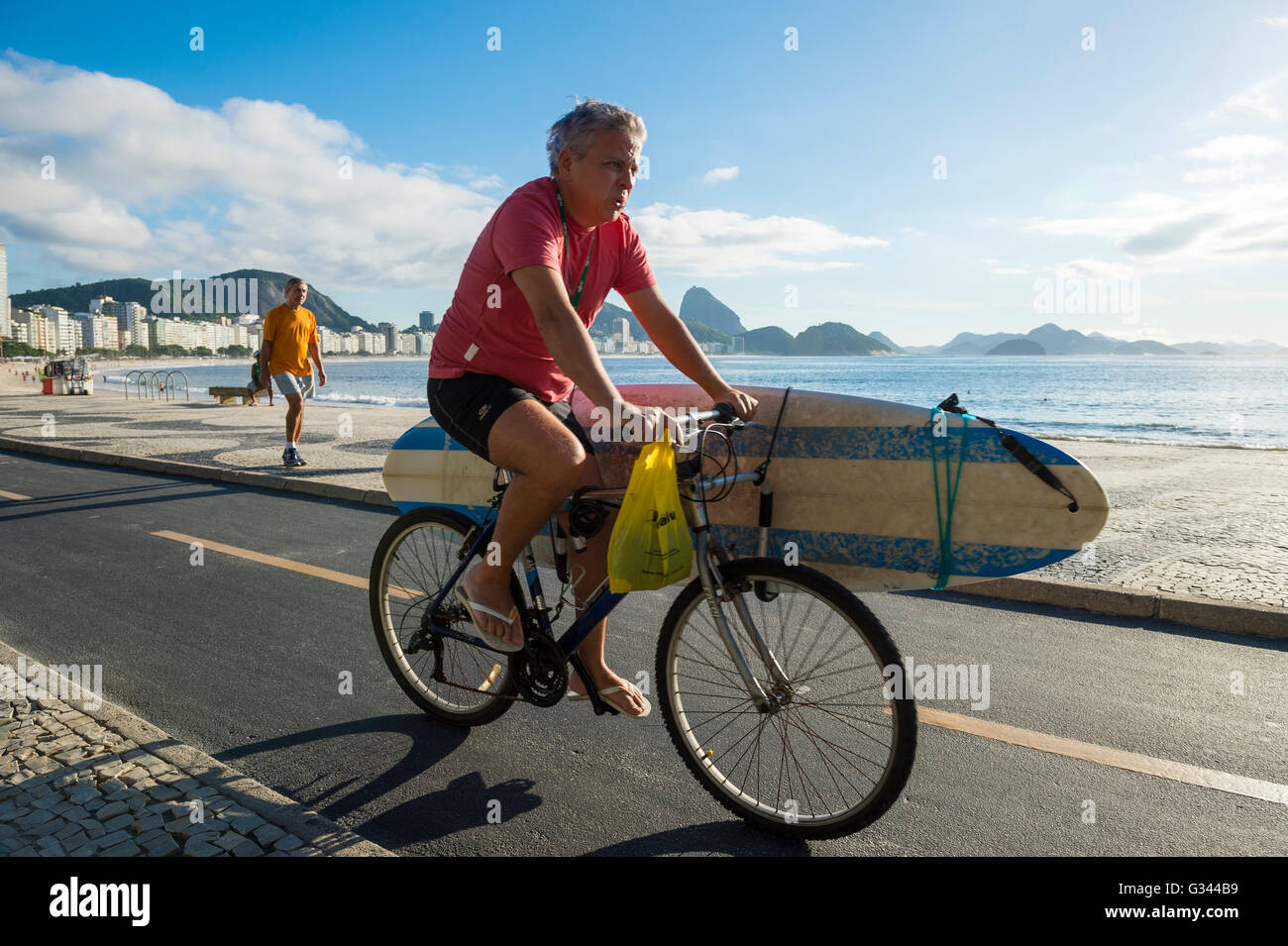 Surfer on bicycle with surfboard hi res stock photography and images Alamy