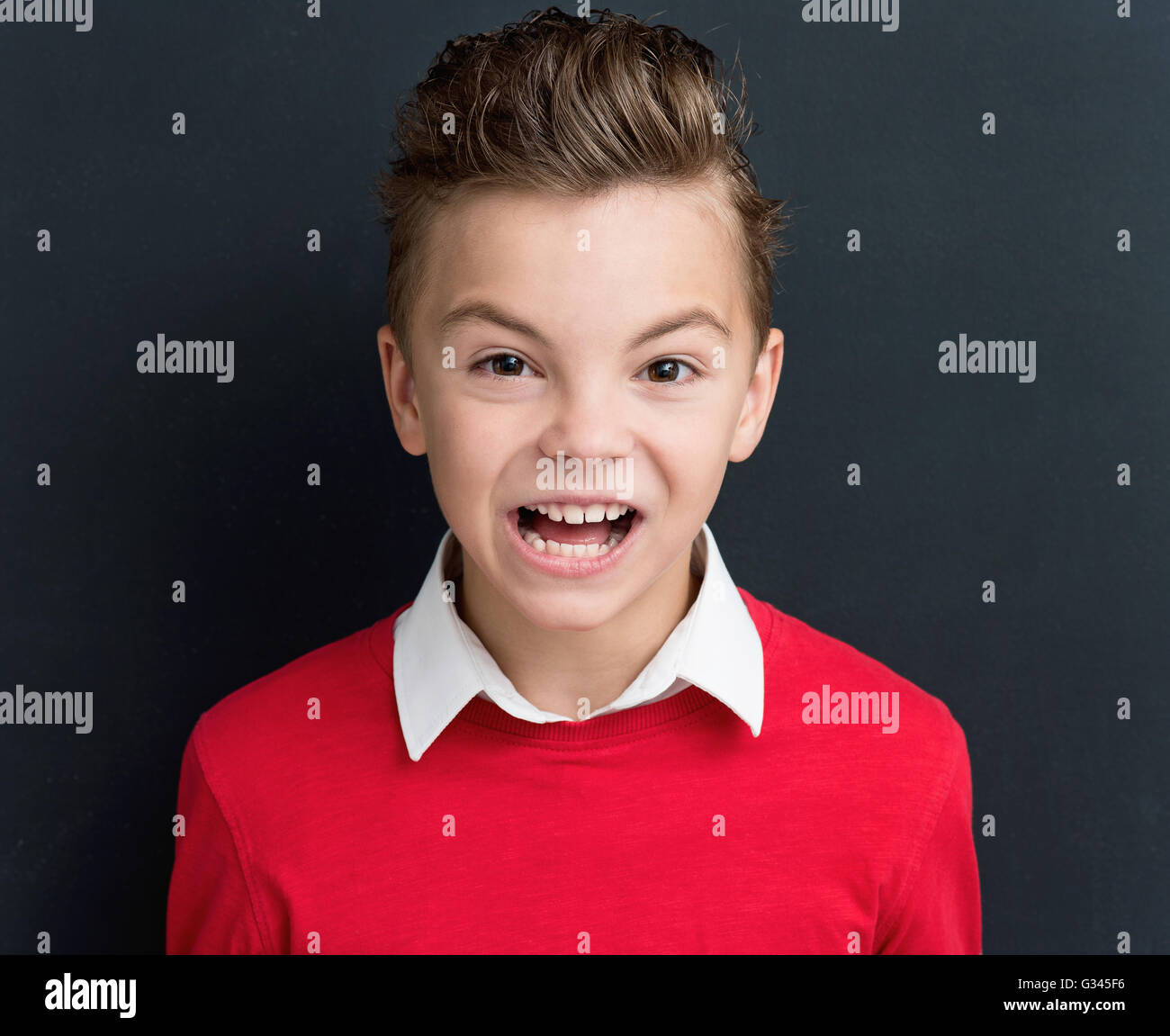 Boy crying at the black chalkboard Stock Photo