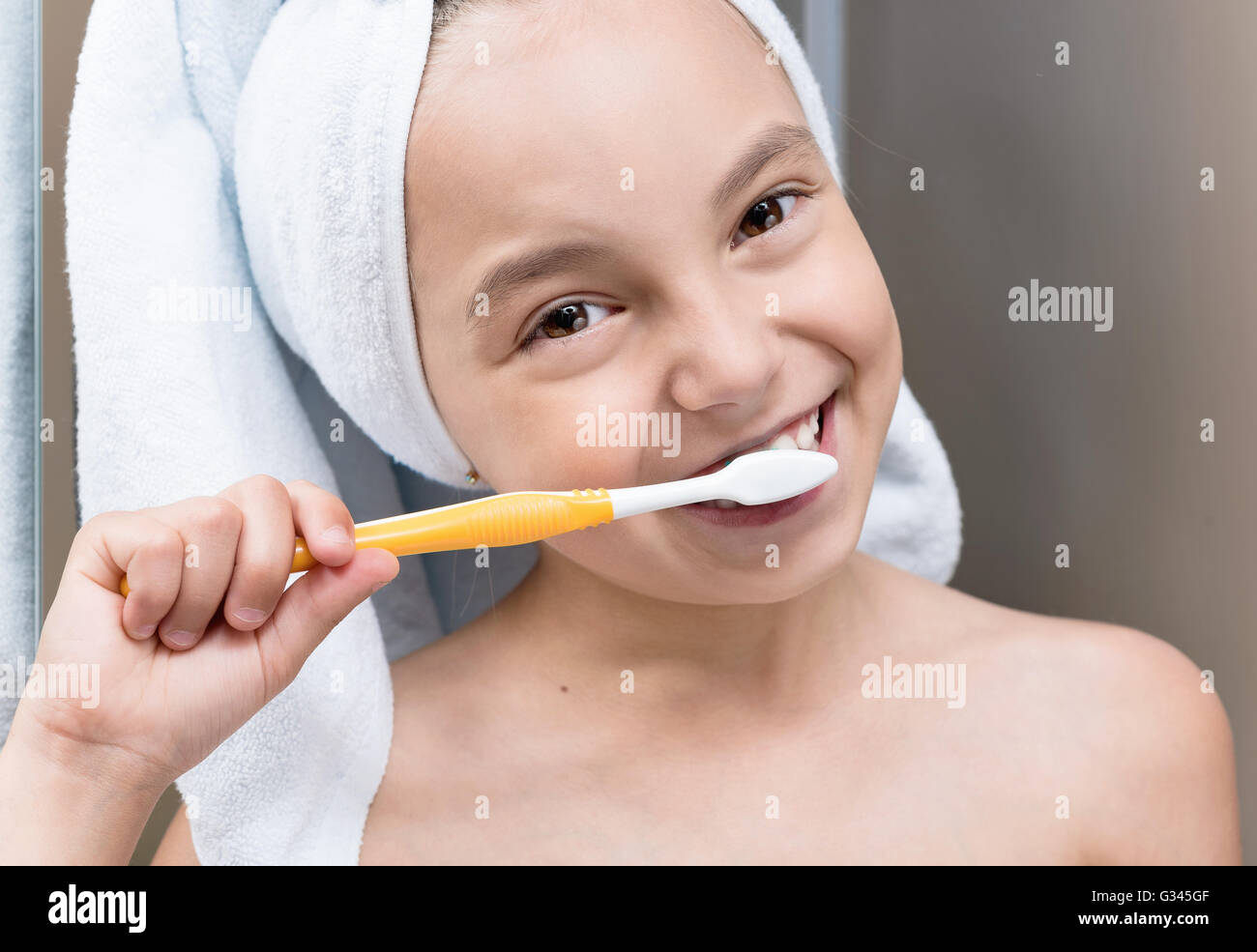 Smiling little girl brushing teeth Stock Photo