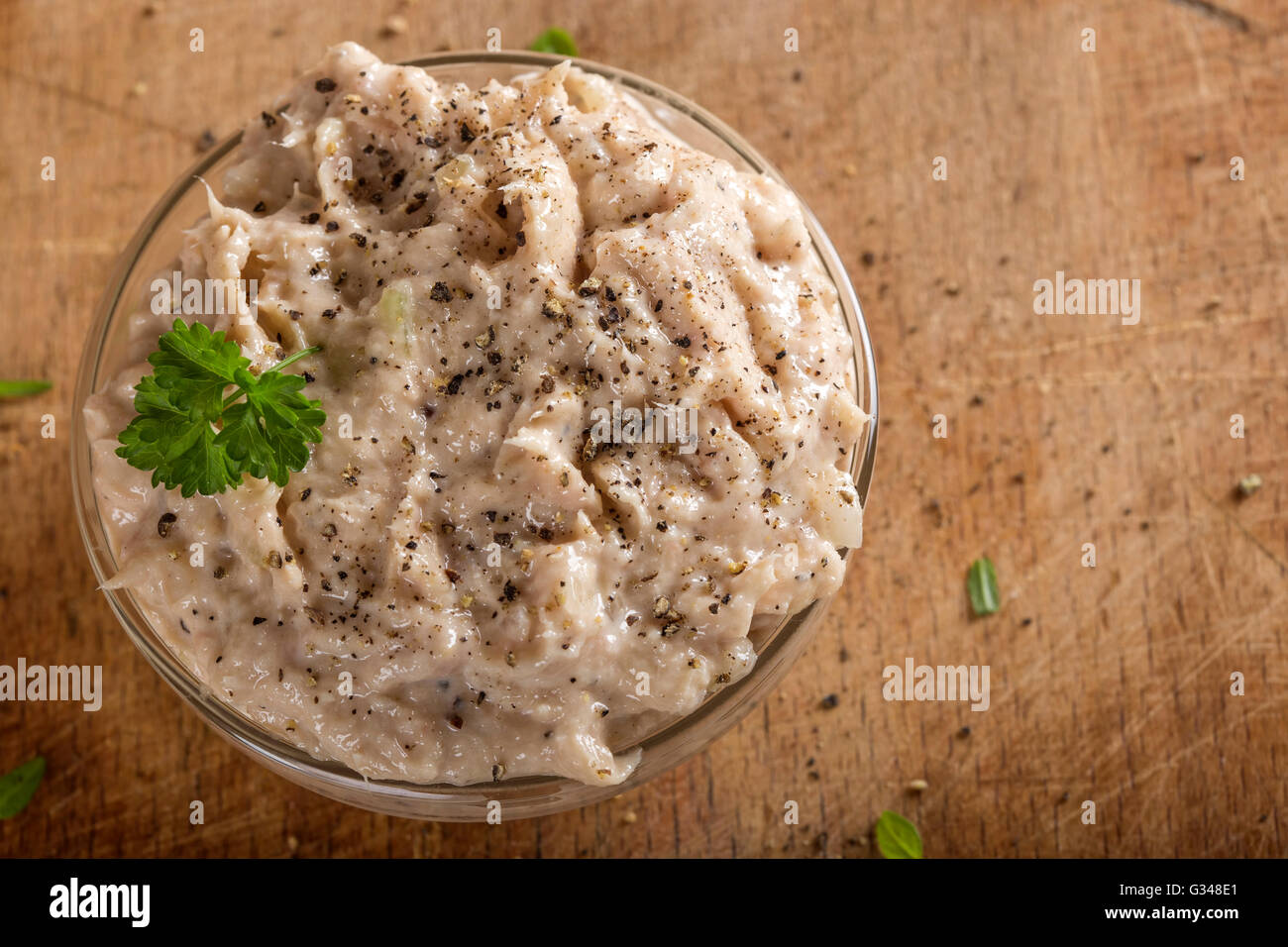 Creamy fish pate in bowl made with tuna, onion and butter Stock Photo