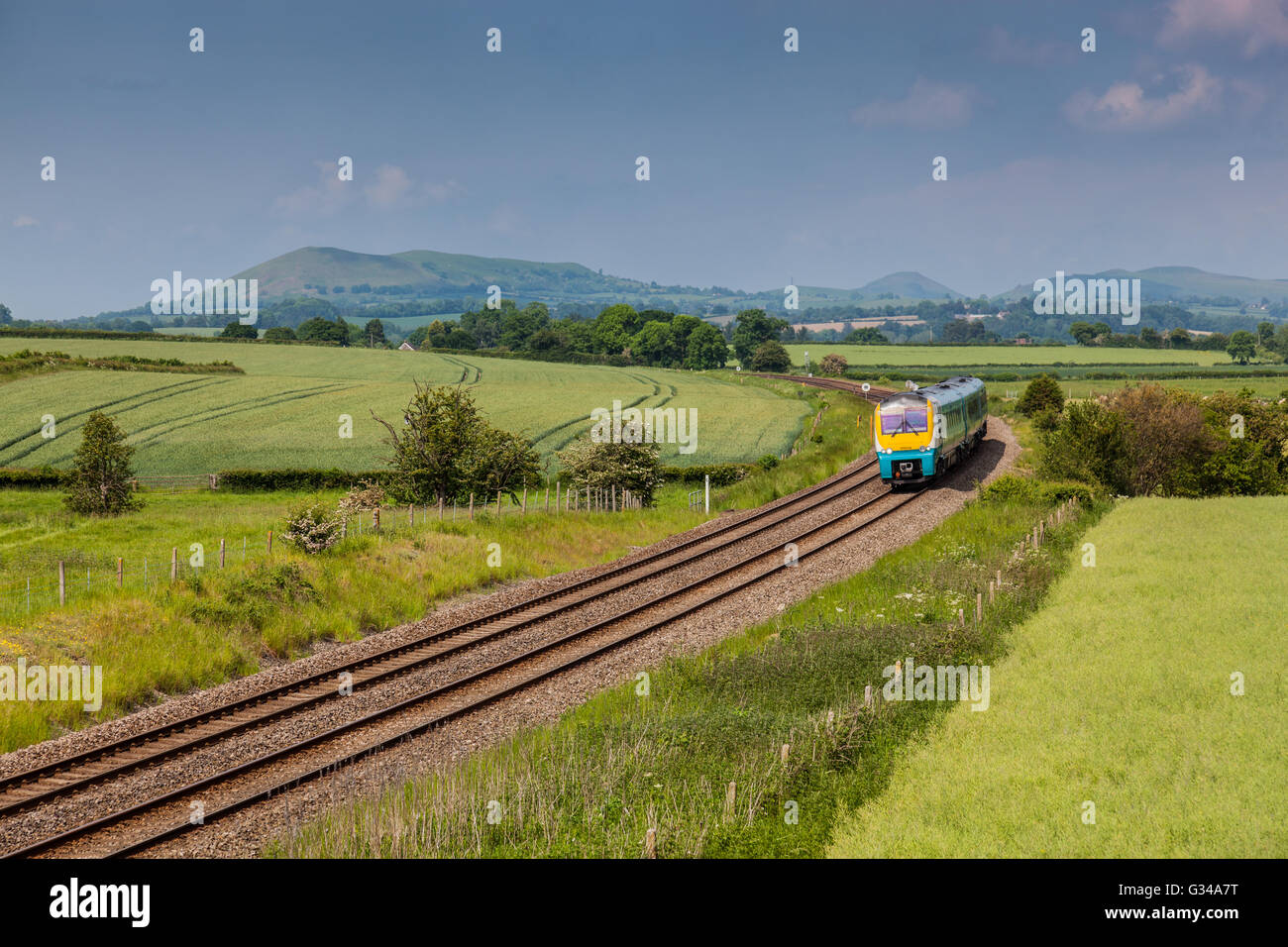 Arriva Trains Wales service on the Marches Line (Cardiff to Manchester) between Craven Arms And Church Stretton, Shropshire Stock Photo