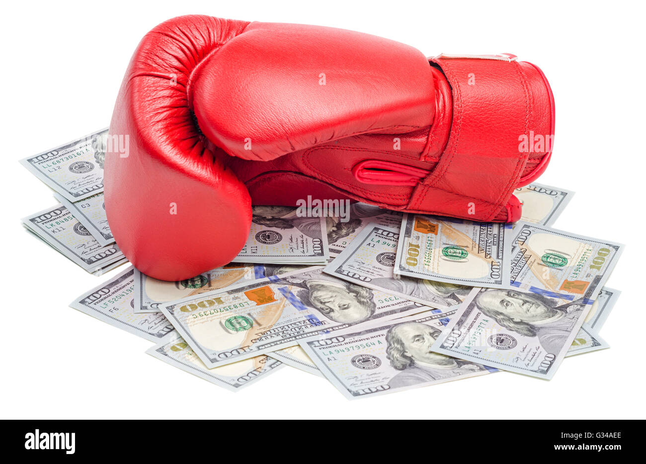 Red boxing glove on top of dollars bills isolated on white background