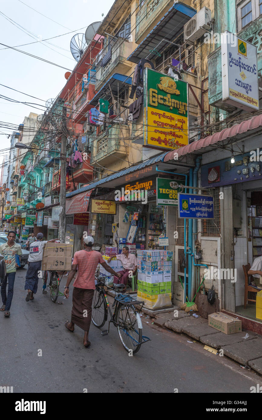 People, shops and coffee shops in a street of Yangon Yangoon, Myanmar, Burma, Birma, South Asia
