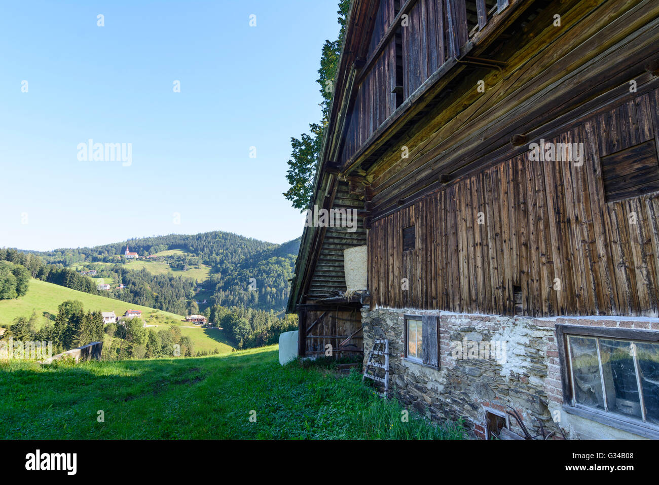 Stubalpe : dilapidated barn , farm houses and church in Sankt Johann, Austria, Steiermark, Styria, Südwest-Steiermark, Maria Lan Stock Photo