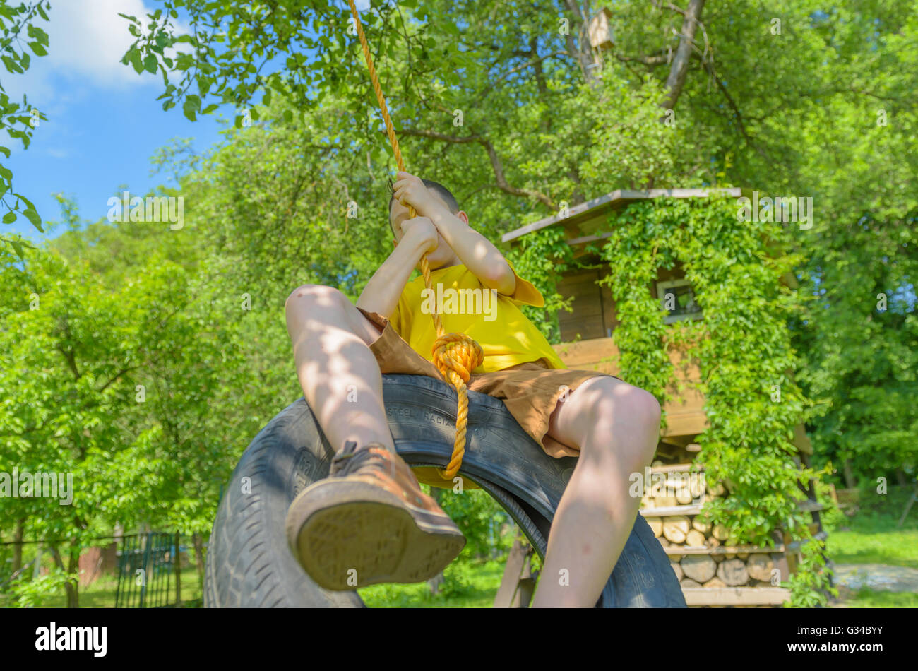 Smiling boy on treehouse. Summer time! Stock Photo