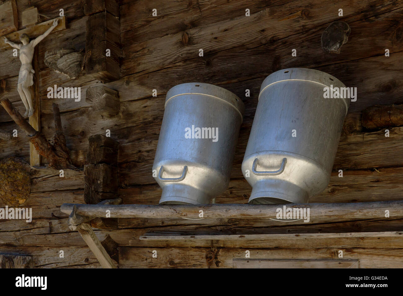 Milk cans in a alpine hut. Rustic farming scene. Stock Photo