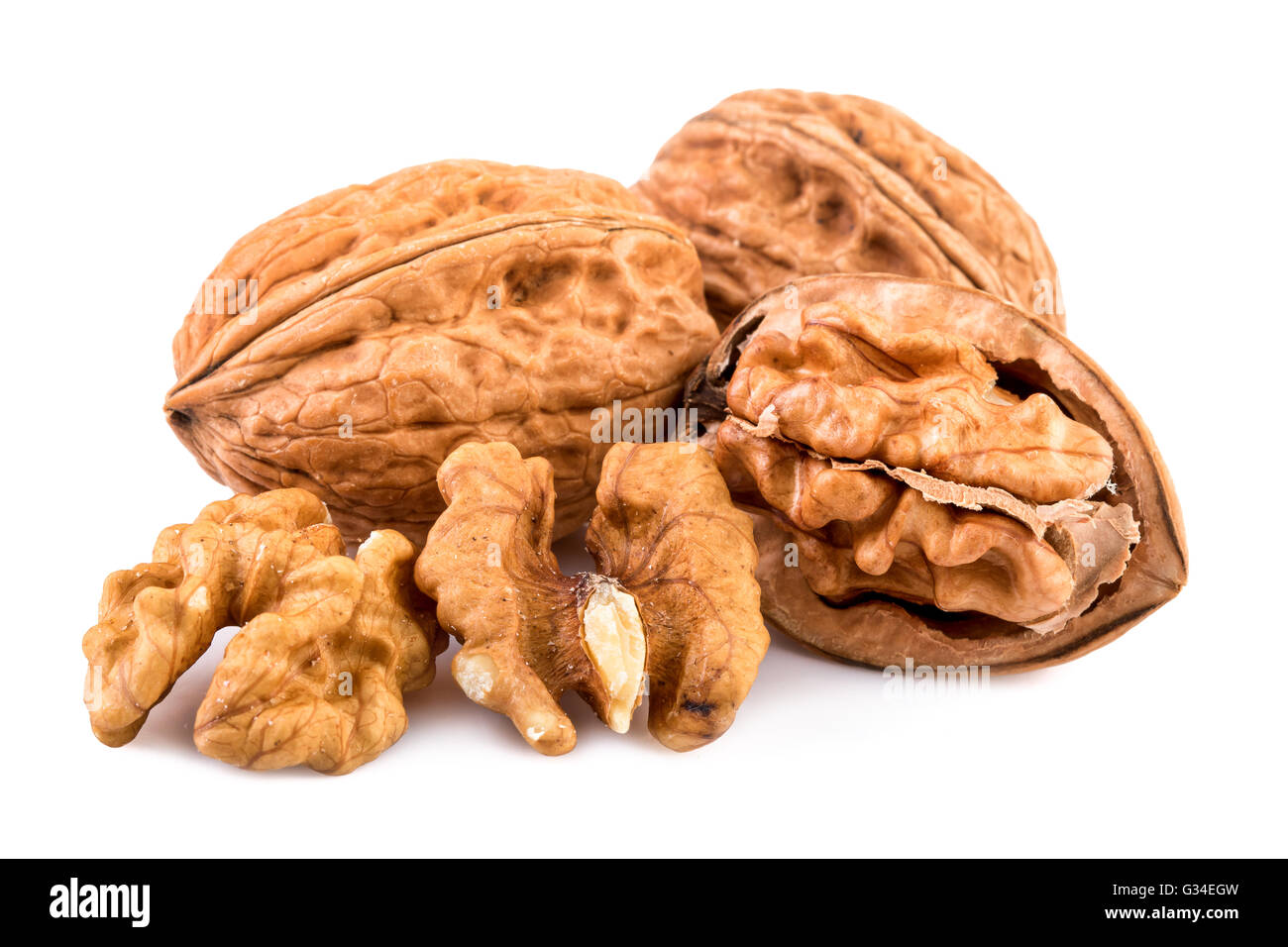 Walnuts and shelled walnuts on white background. Closeup. Stock Photo
