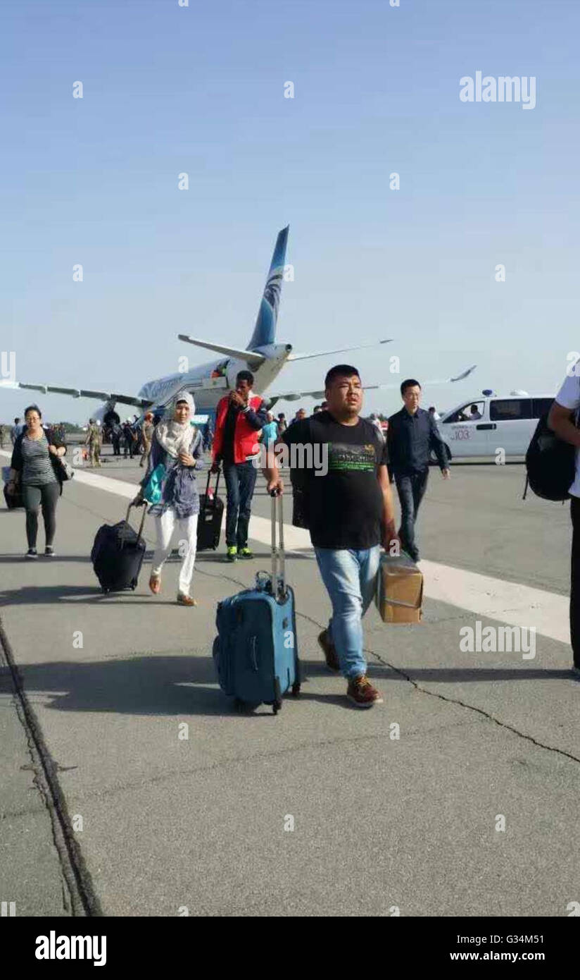 Uzbekistan. 8th June, 2016. Passengers and crew members aboard the EgyptAir plane are evacuated in Uzbekistan on June 8, 2016. A bomb threat on an EgyptAir flight from Cairo to Beijing was proved to be a hoax and the flight will continue after an emergency landing in Uzbekistan on Wednesday. No explosives were found after all the 118 passengers and 17 crew members were evacuated for a search, announced the Uzbekistan Airways. Credit:  Xinhua/Alamy Live News Stock Photo