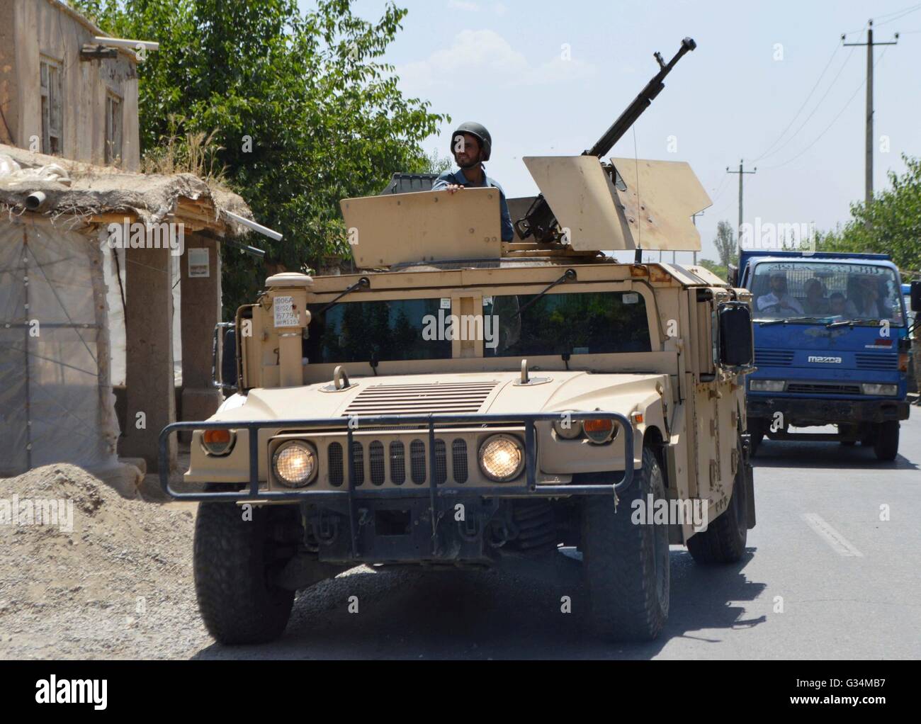 Kunduz, Afghanistan. 8th June, 2016. An Afghan policeman stands on a military vehicle at the site of kidnapping in Kunduz province, Afghanistan, June 8, 2016. Armed militants intercepted a bus along a main roadway in Afghanistan's northern province of Kunduz on Wednesday, kidnapping several passengers, sources said. Credit:  Ajmal Kakar/Xinhua/Alamy Live News Stock Photo