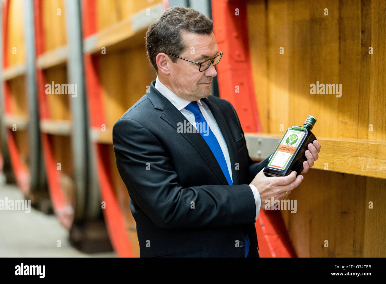 Wolfenbuettel, Germany. 07th June, 2016. Paolo Dell Antonio, spokesman of the Mast-Jaegermeister AG board, poses with a bottle of Jaegermeister at the corporate headquarters of the liquor company in Wolfenbuettel, Germany, 07 June 2016. Photo: PETER STEFFEN/dpa/Alamy Live News Stock Photo