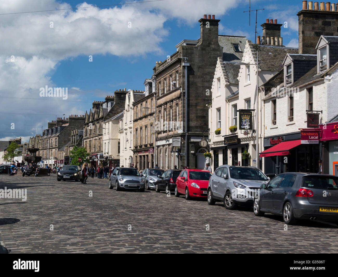 View along Market Street historic Royal Burgh St Andrews Fife Scotland cobbled street flanked by shops cafes restaurants pubs in historic buildings Stock Photo