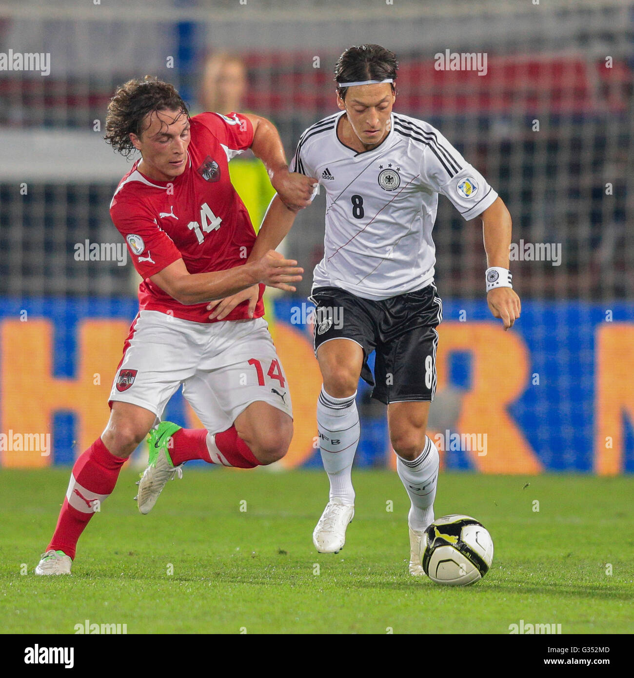 Mesut Oezil, #8 Germany, and Julian Baumgartlinger, 14 Austria, fight for the ball during the WC qualifier soccer game on Stock Photo