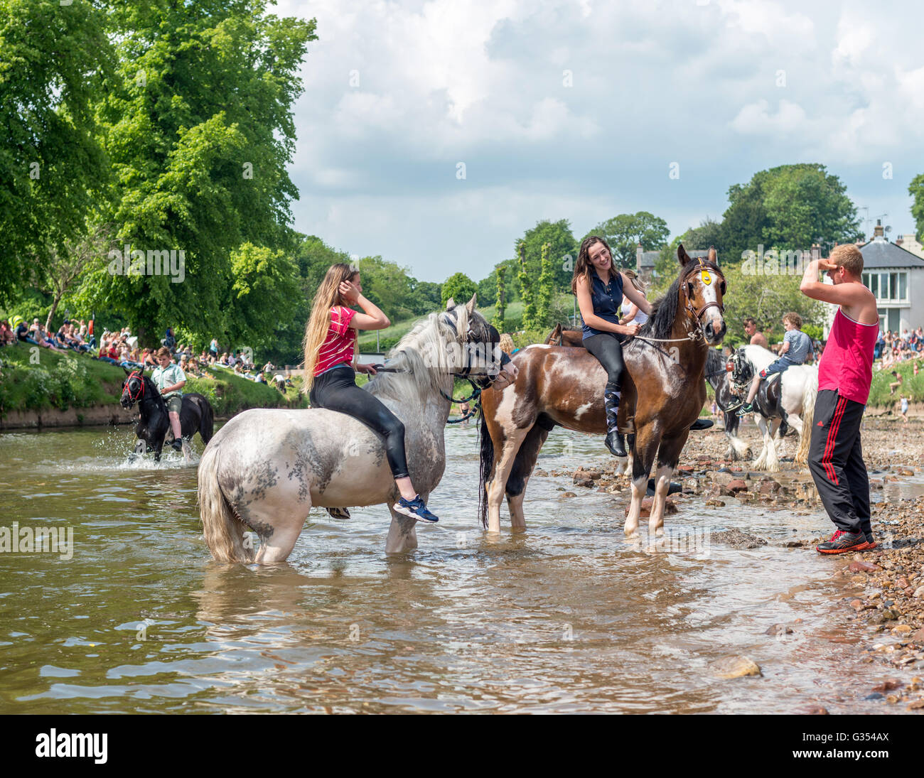 Travellers washing riding their horses in the river Eden at Appleby