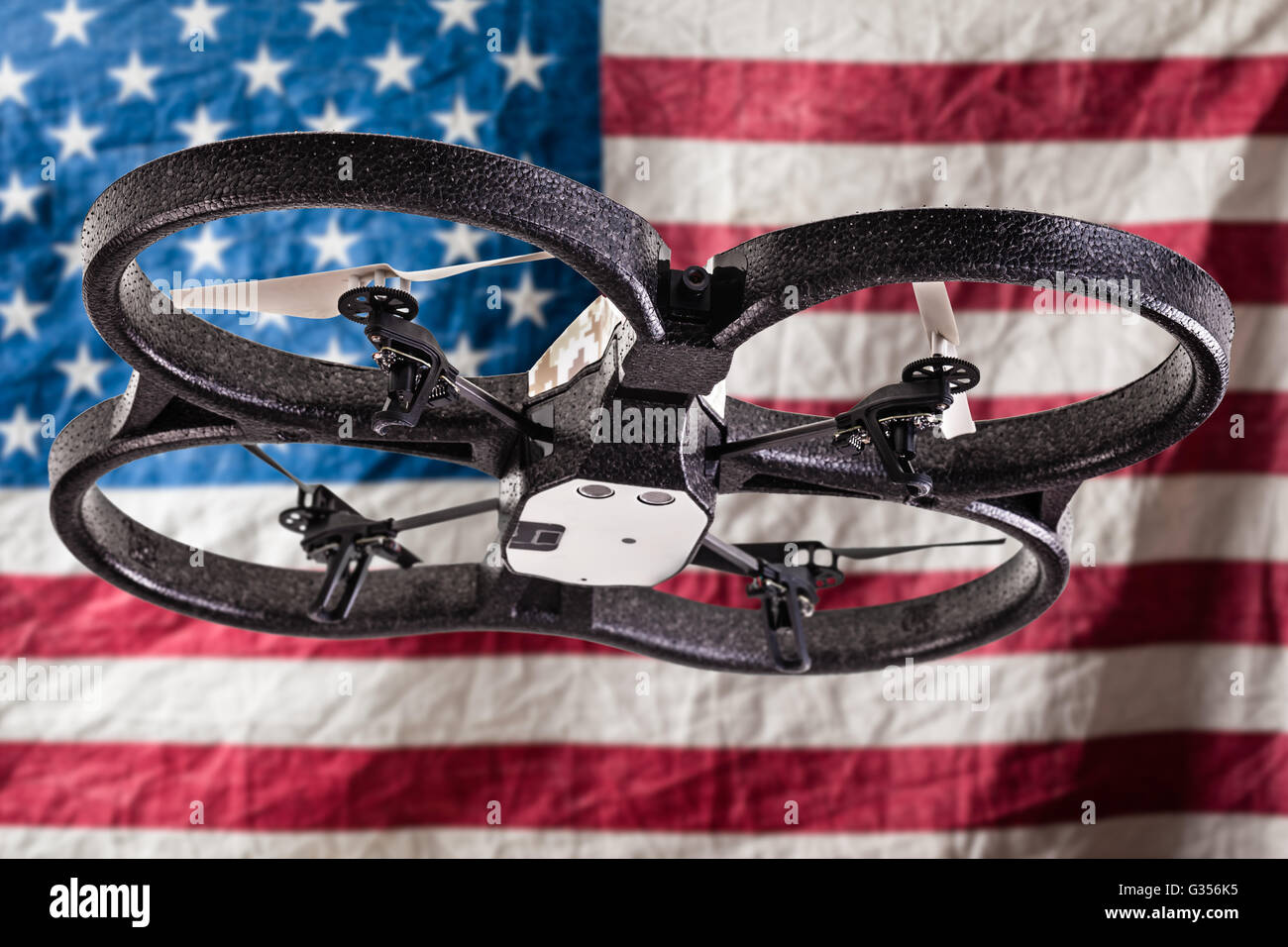 a small spy quad copter drone flying over a wrinkled usa flag Stock Photo -  Alamy