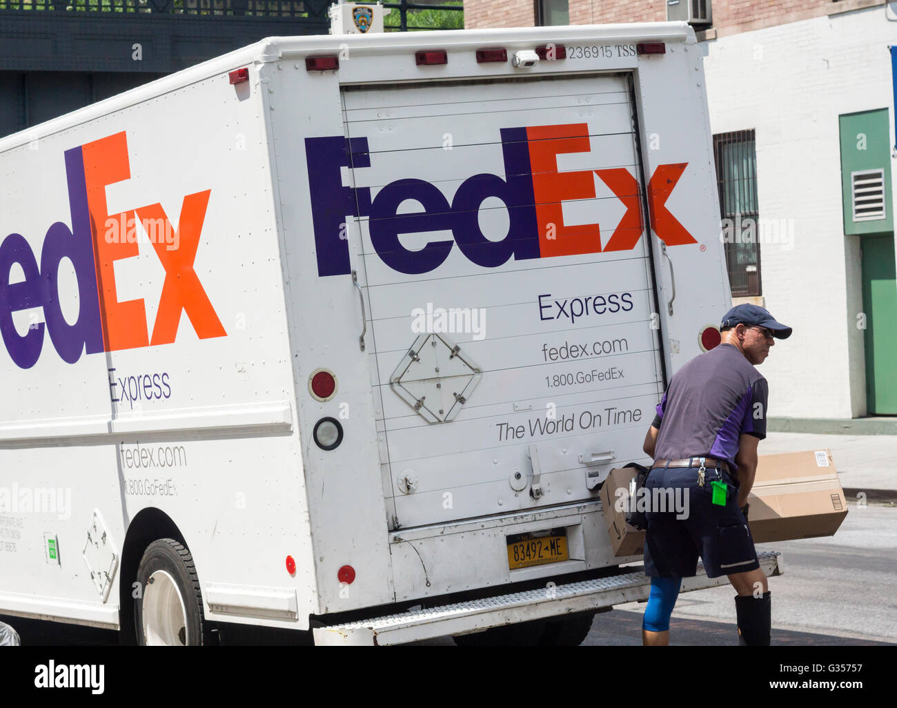 A FedEx worker in New York locks up his truck and prepares to deliver a package on Tuesday, May 31, 2016. (© Richard B. Levine) Stock Photo