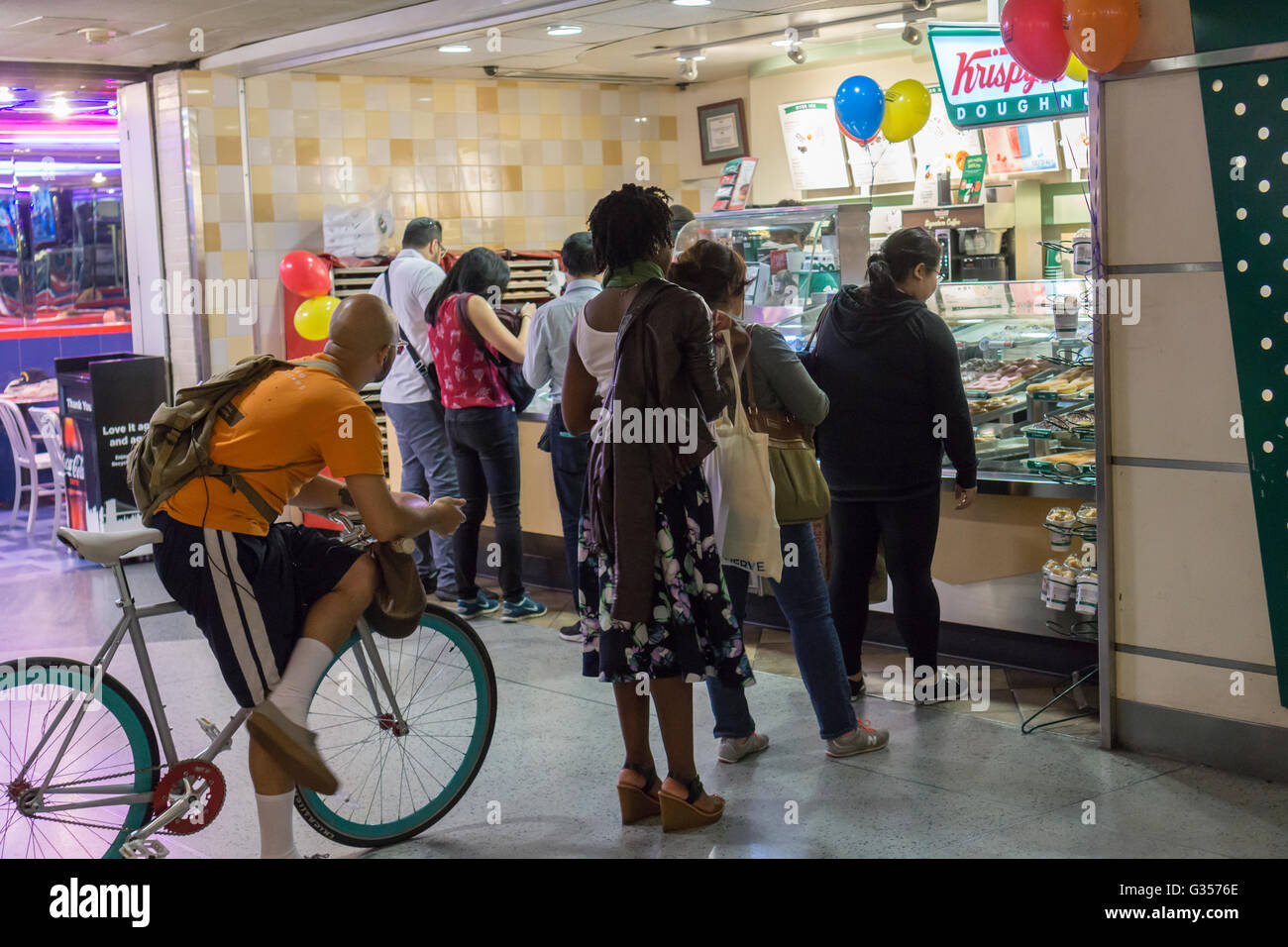 Customers clamor around the Krispy Kreme in Penn Station in New York for a free donut celebrating National Donut Day  on Friday, June 3, 2016. National Donut Day, the first Friday in June, was created in 1938 by the Salvation Army to honor the 'donut lassies' who administered treats and solace to soldiers during WW1. (©  Richard B. Levine) Stock Photo