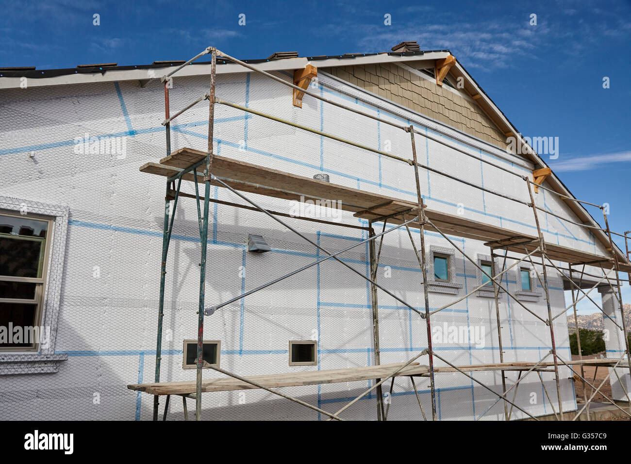 Home building industry house scaffolding for stucco and insulation foam Stock Photo