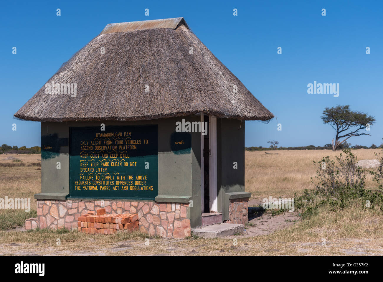 Thatched toilet Block Nyamandhlovu Pan in Hwange National Park Stock Photo