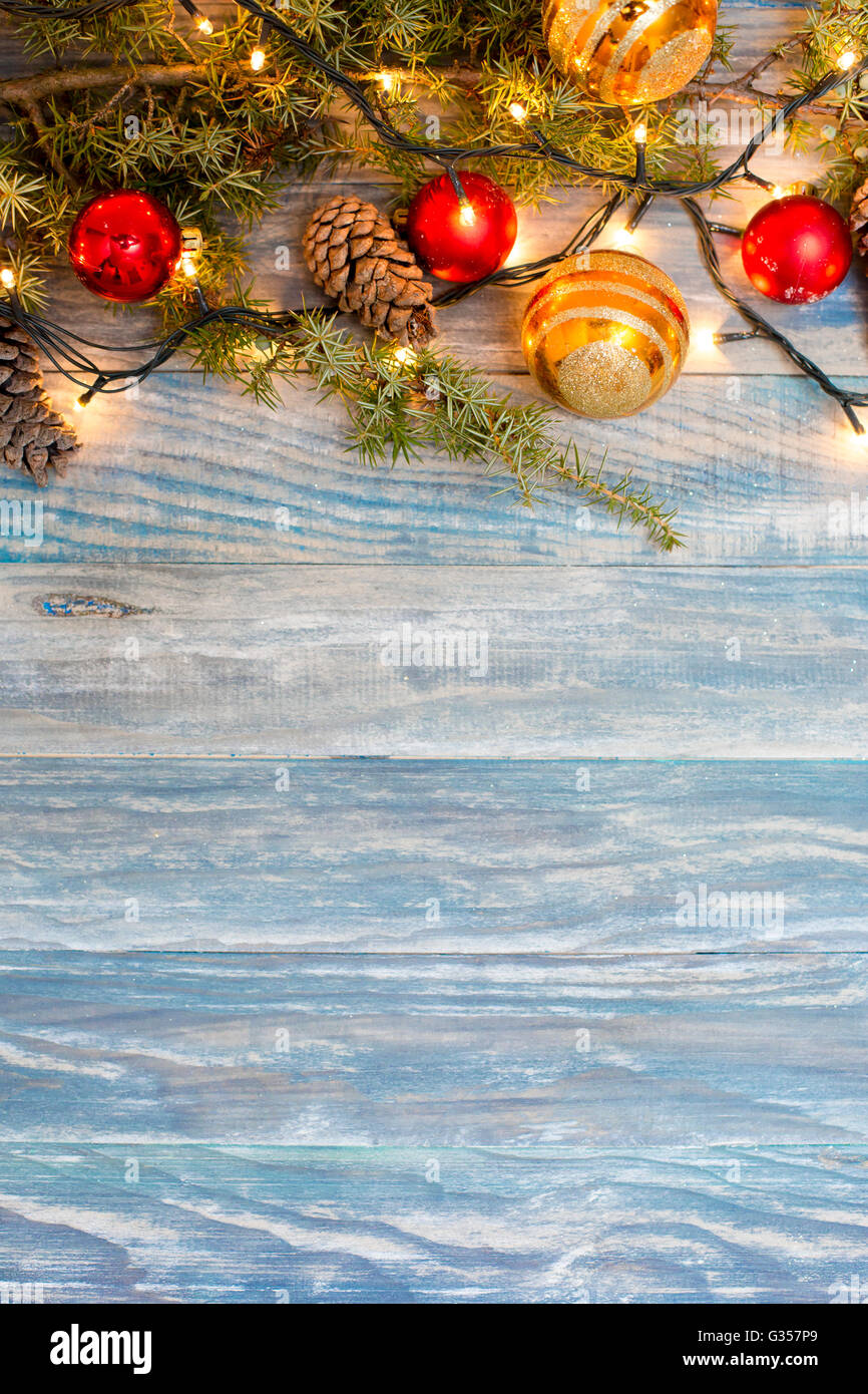 Christmas background with fir branches,pinecones and berries on the old ...