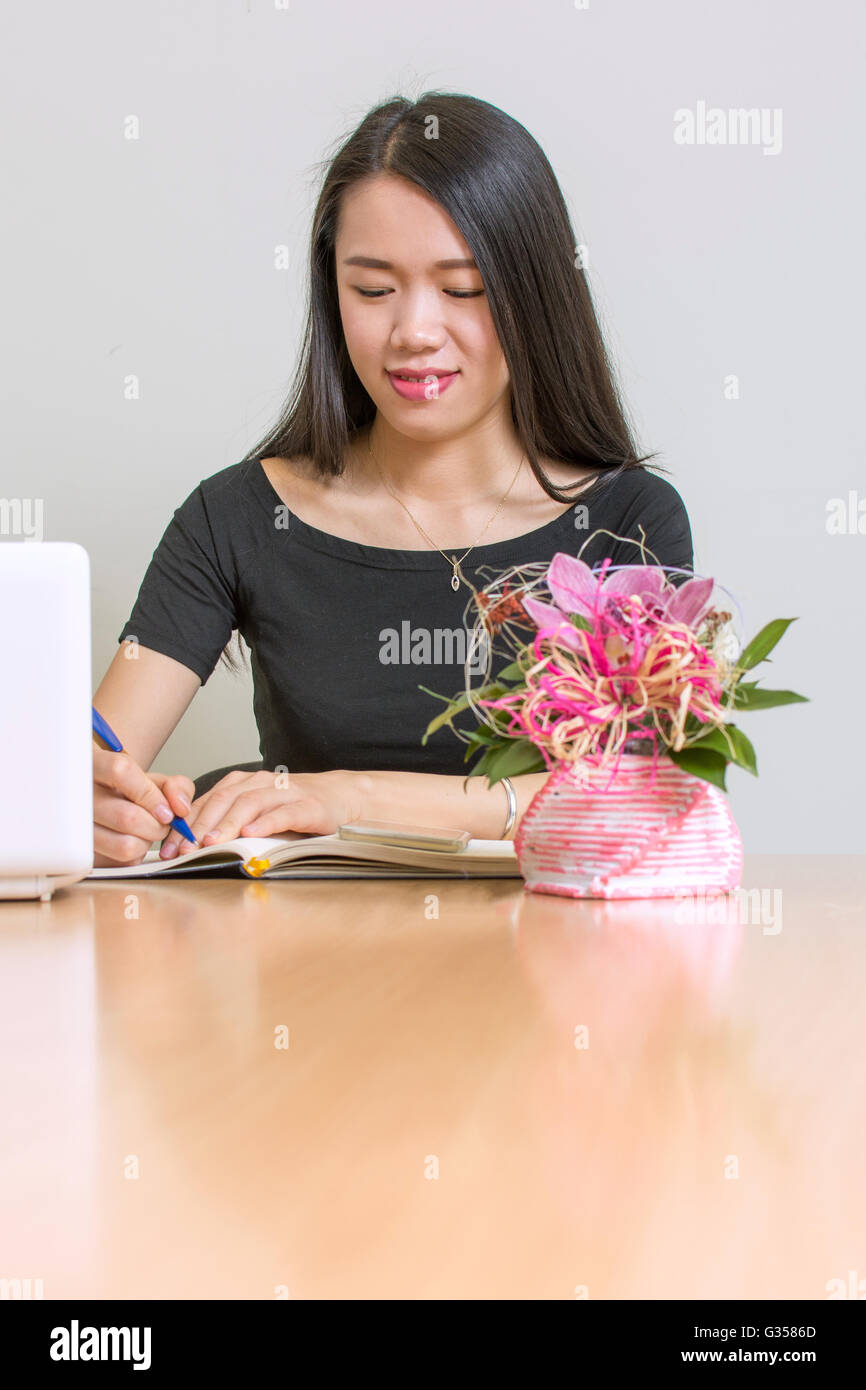 Beautiful asian woman working on a laptop Stock Photo