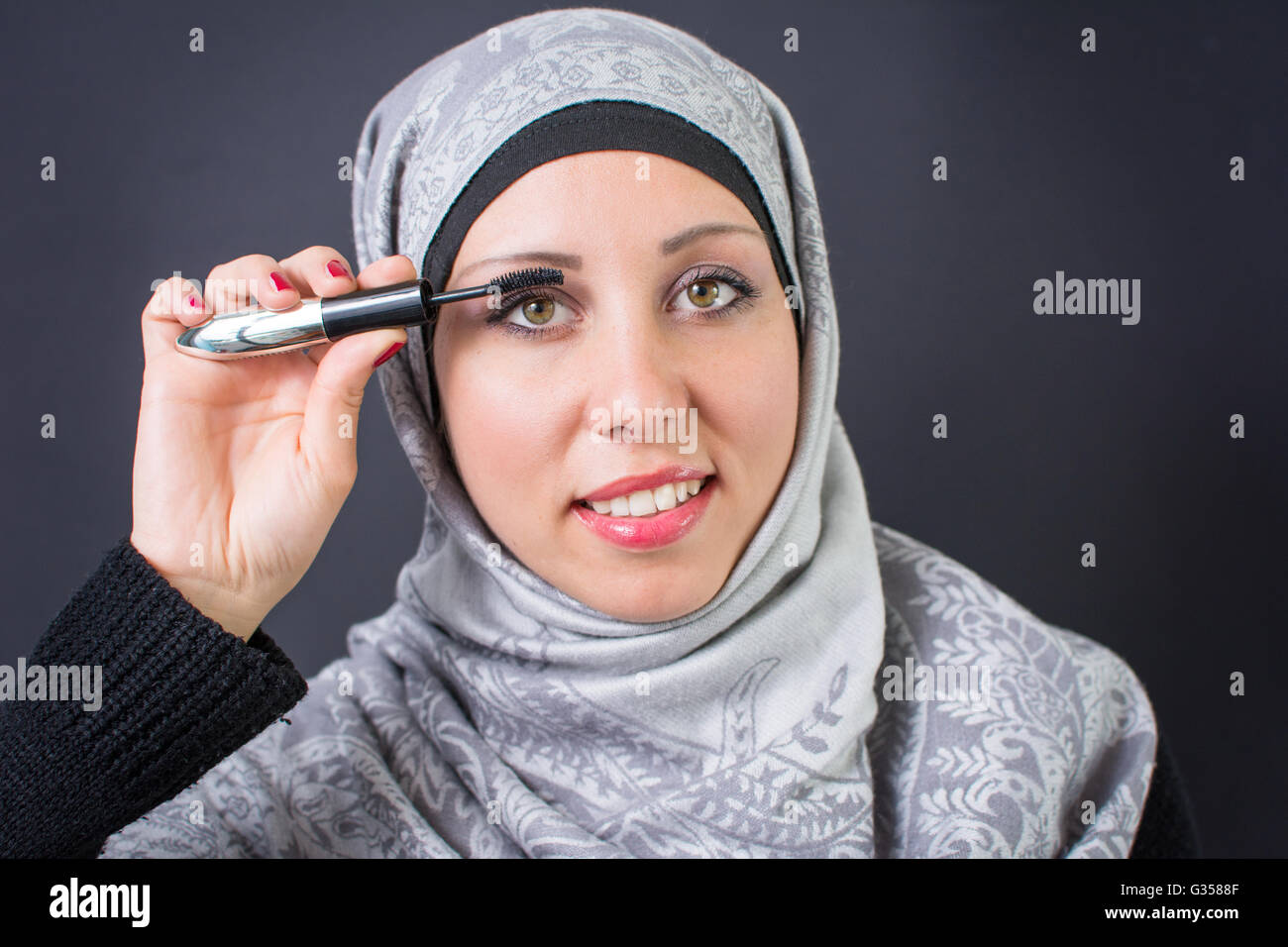 Beautiful muslim woman applying mascara Stock Photo