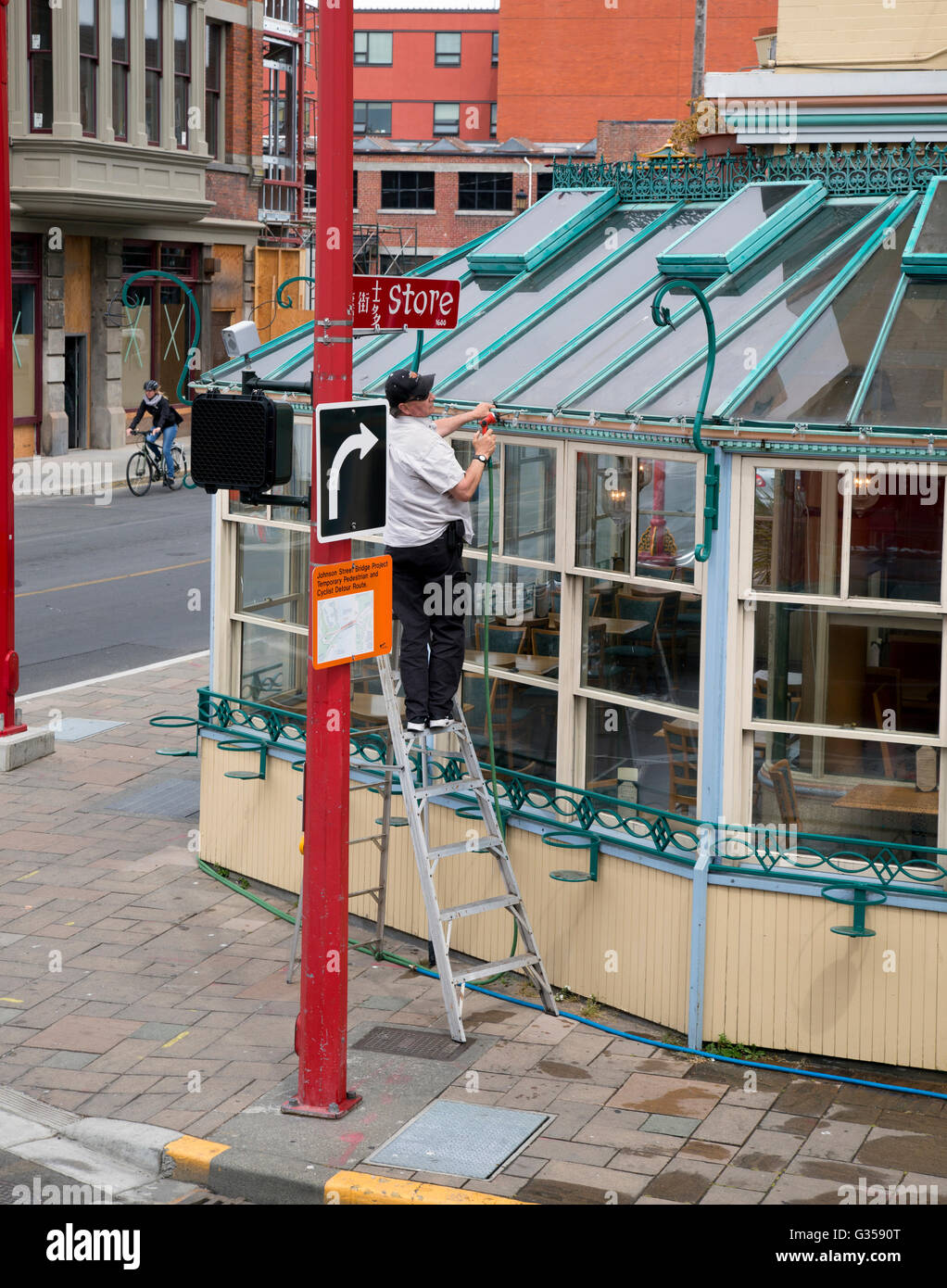 Worker repairing windows. Downtown Victoria, BC Stock Photo Alamy