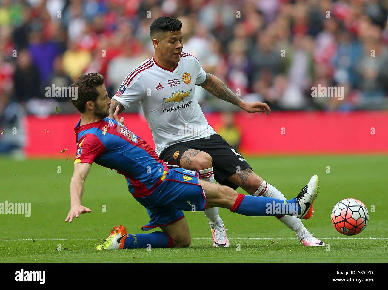 Crystal Palace’s Yohan Cabaye  slides in to tackle Marcos Rojo of Manchester United  during the Emirates FA Cup Final between Crystal Palace and Manchester United at Wembley Stadium in London. May 21, 2016. EDITORIAL USE ONLY. No use with unauthorized audio, video, data, fixture lists, club/league logos or 'live' services. Online in-match use limited to 75 images, no video emulation. No use in betting, games or single club/league/player publications. James Boardman / Telephoto Images +44 7967 642437 James Boardman / Telephoto Images +44 7967 642437 Stock Photo