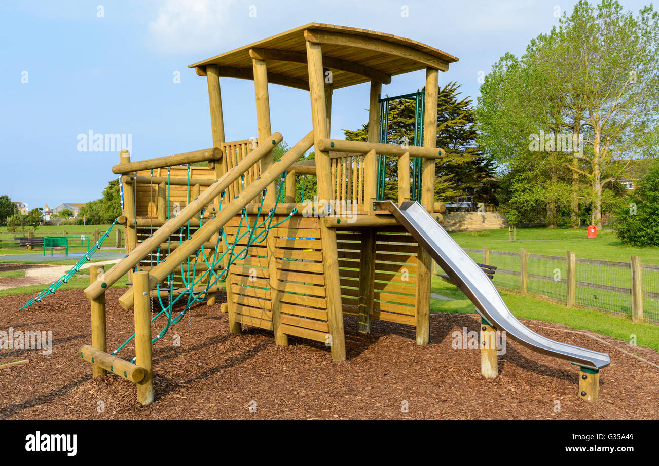 Wooden climbing frame in a childs playground in a park in the UK. Stock Photo