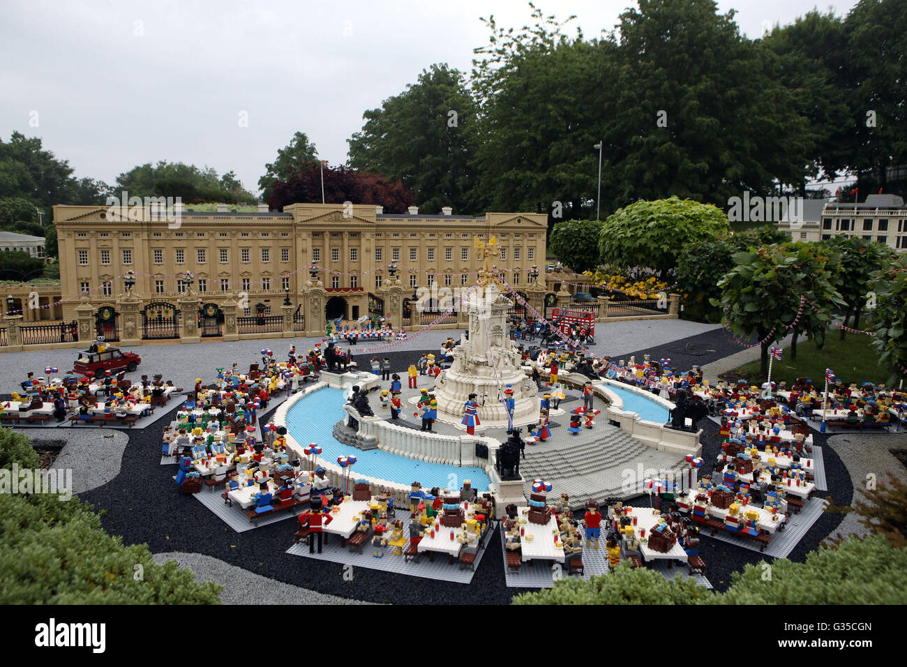 LEGOLAND Windsor Resort in Windsor unveils a miniature street party outside a model of Buckingham Palace in Miniland ahead of the Patron's Lunch on The Mall in London to mark the Queen's official 90th birthday on June 12. Stock Photo